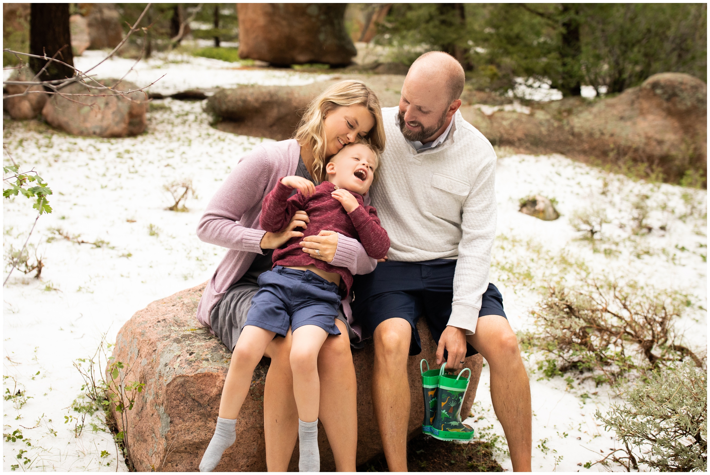 family having tickle fight during candid photography session at Vedauwoo in Wyoming 