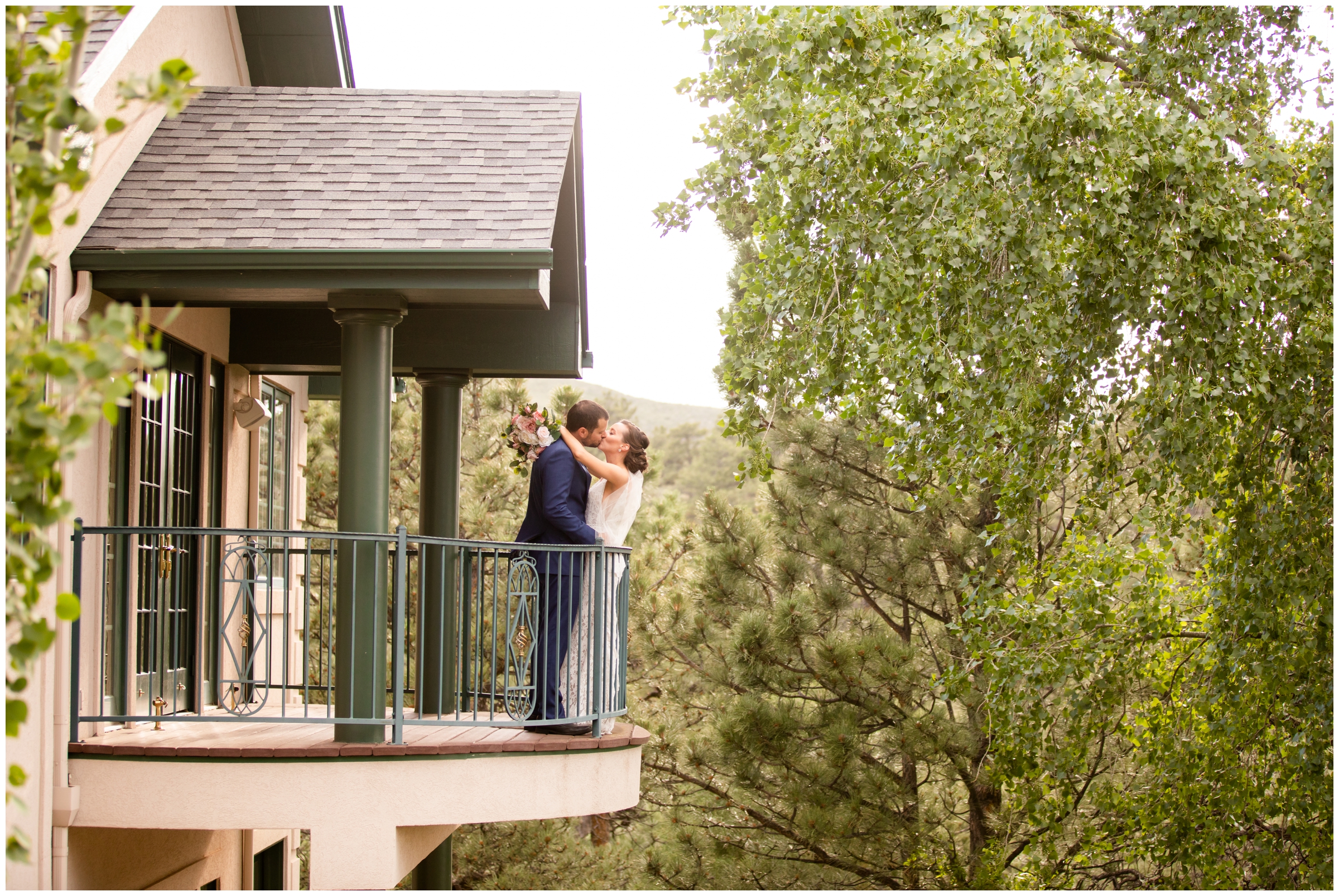 couple kissing on balcony during Colorado mansion wedding in Lyons