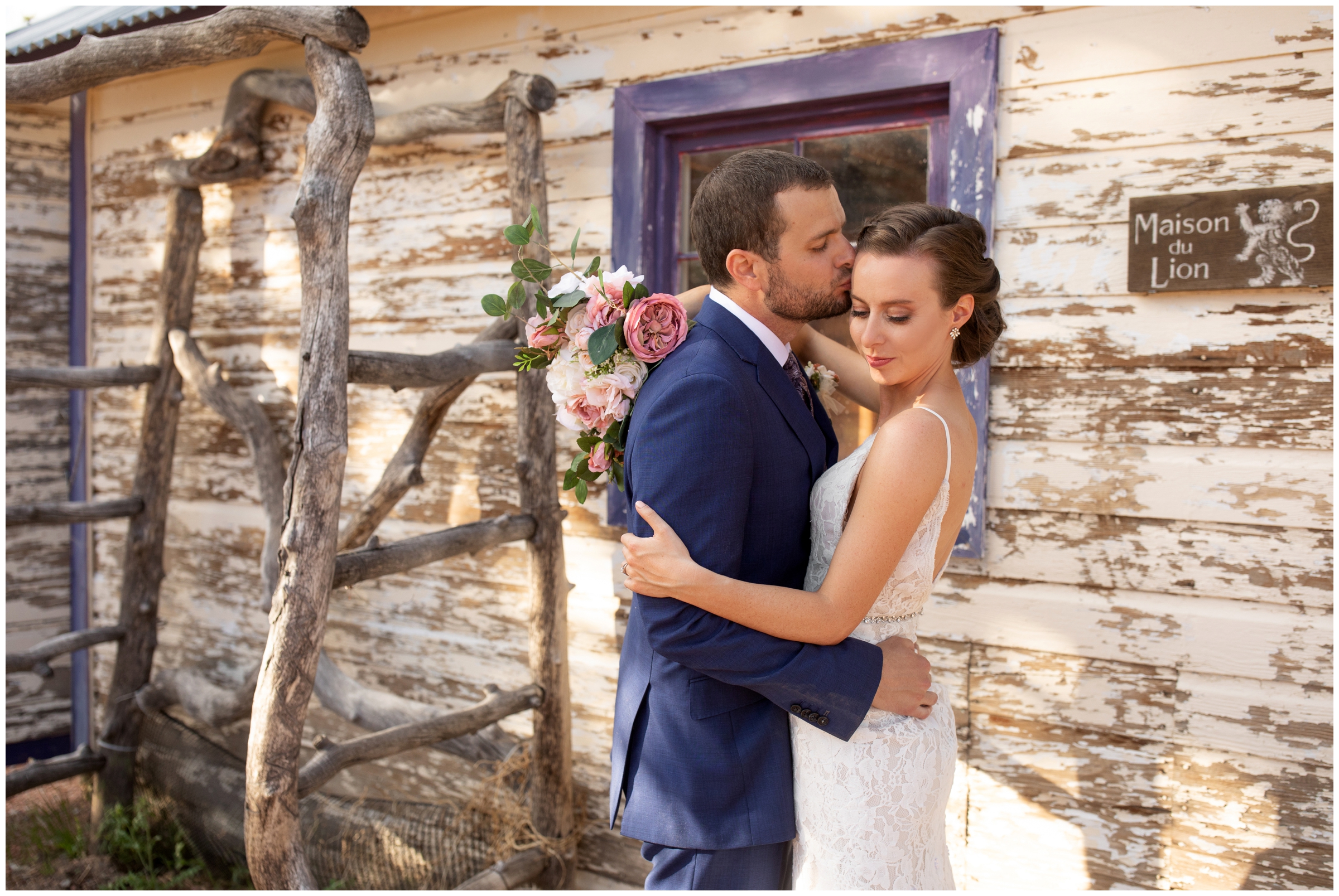 couple embracing in front of rustic wood wall during Lionscrest Manor wedding photos in Lyons Colorado