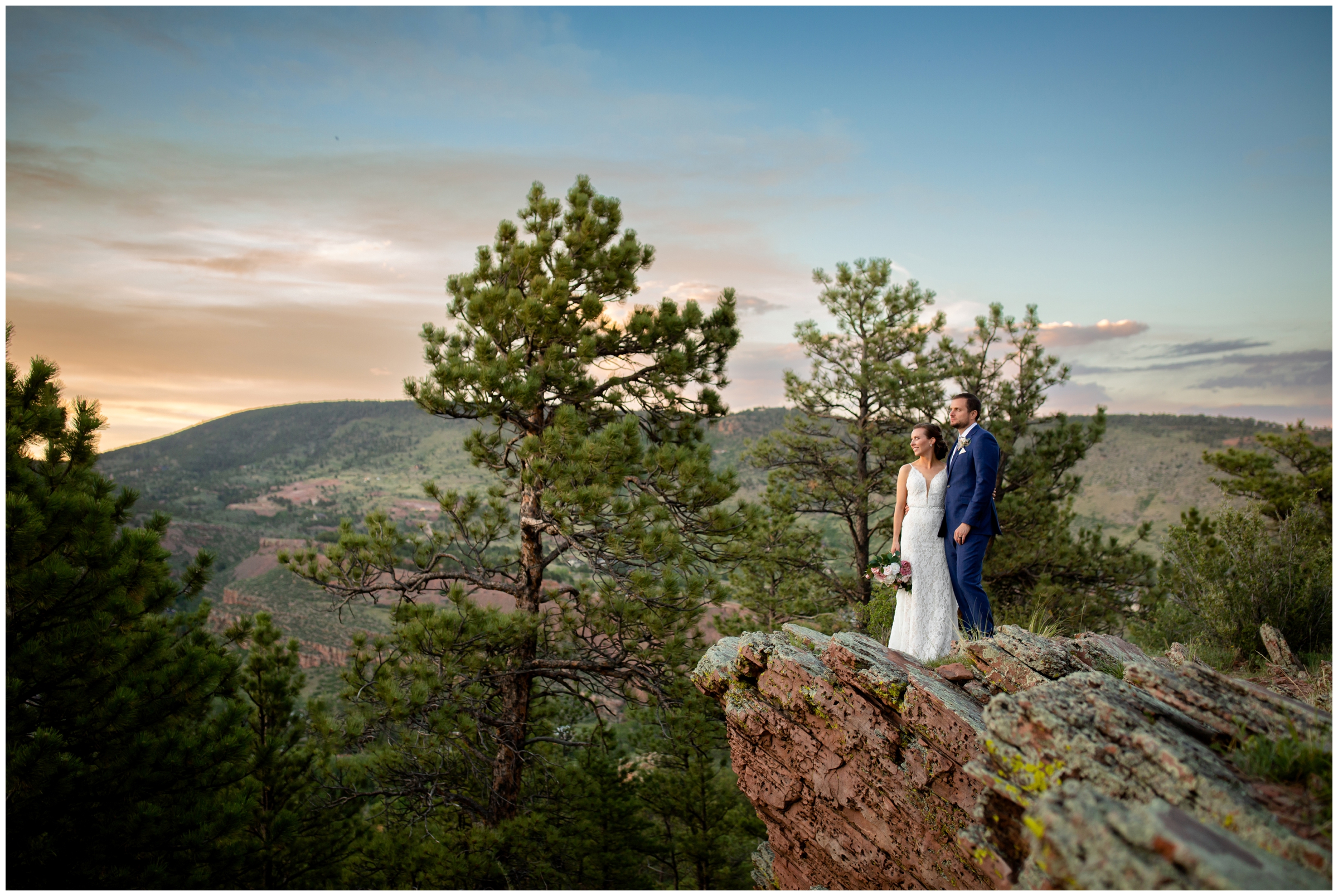 couple posing on edge of mountain at sunset during Lyons Colorado wedding photos at Lionscrest Manor