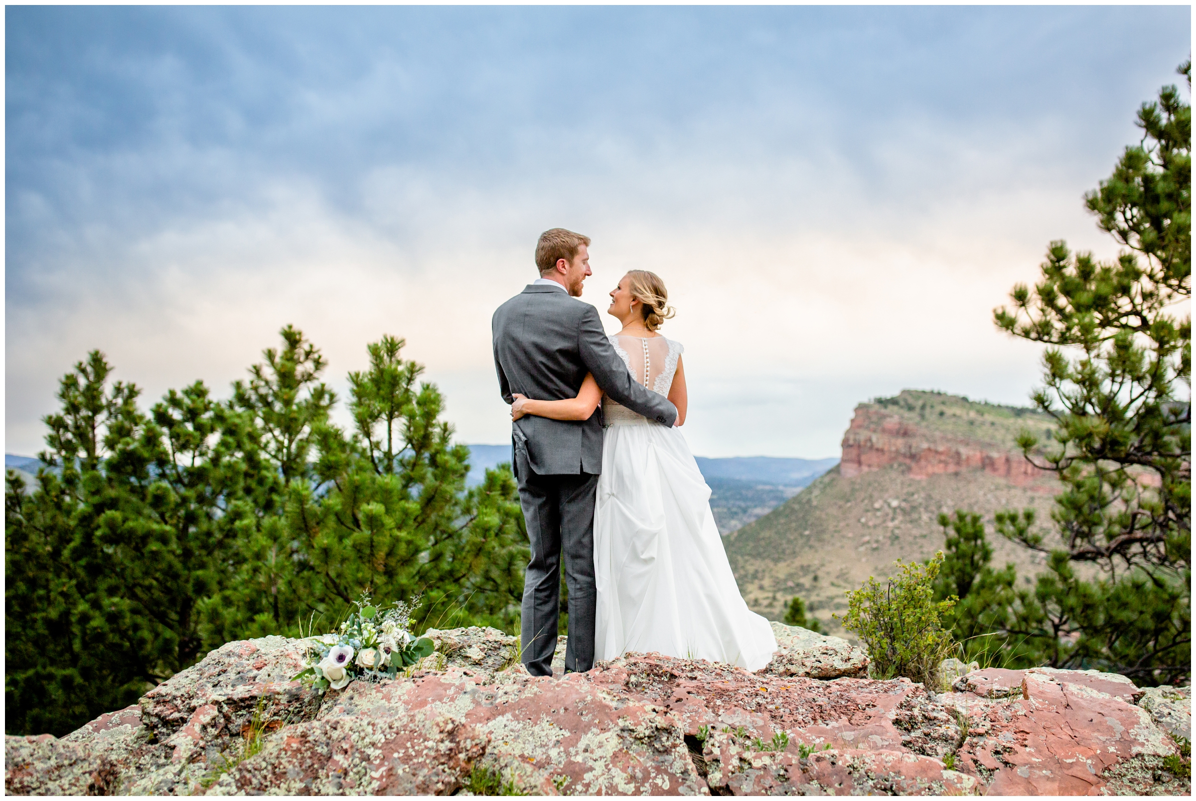 couple posing on edge of mountain during wedding portraits at Lionscrest Manor in Colorado