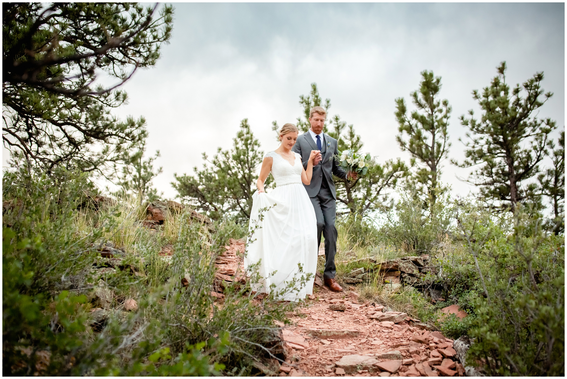 couple holding hands and walking during candid wedding photos in Colorado mountains 