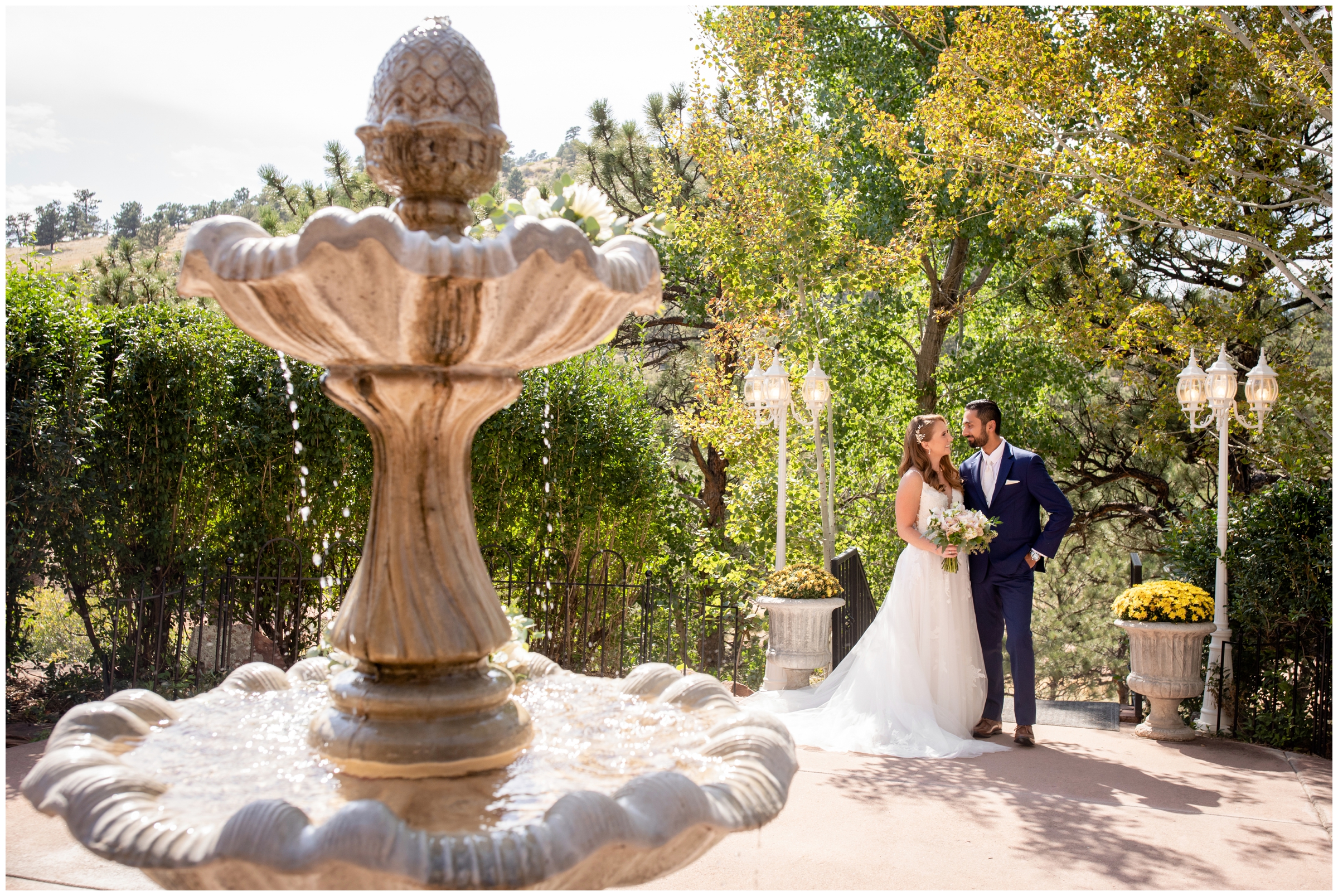 couple posing by water fountain during Lionscrest Manor Colorado mountain wedding