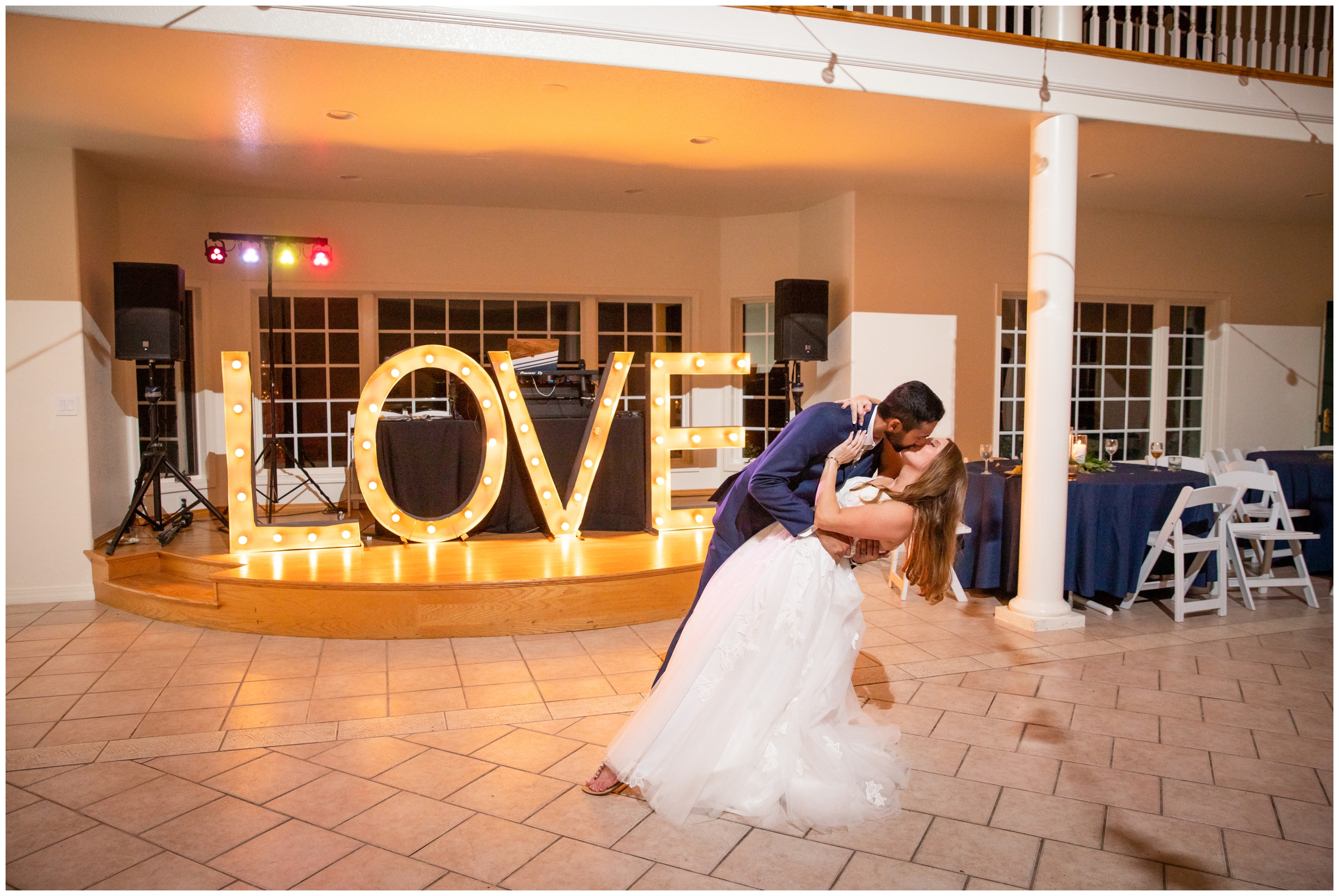 groom dipping bride with marquee letters in background at Lionscrest Manor wedding reception