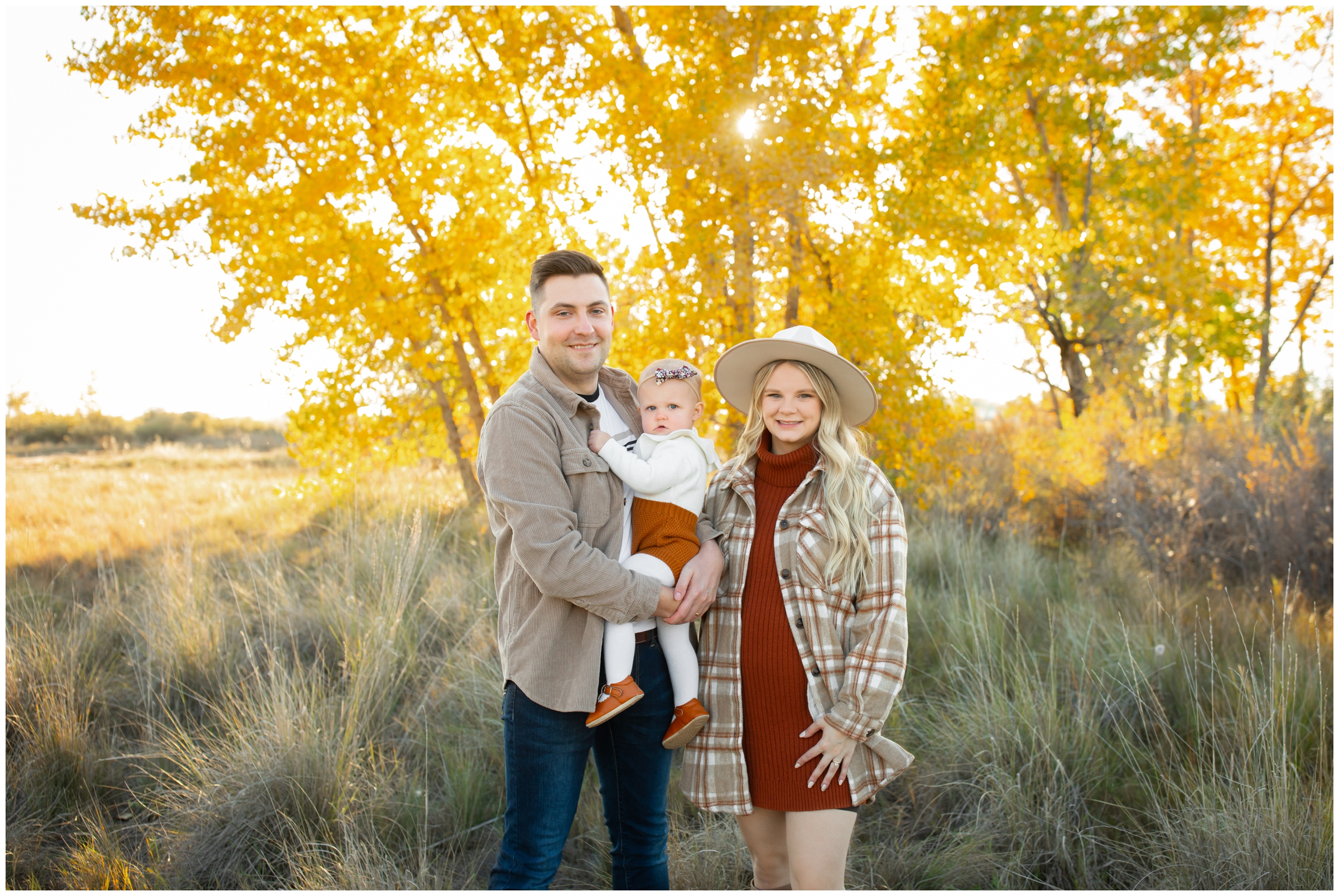 family posing in front of colorful fall foliage during Longmont Colorado family portraits by Plum Pretty Photos