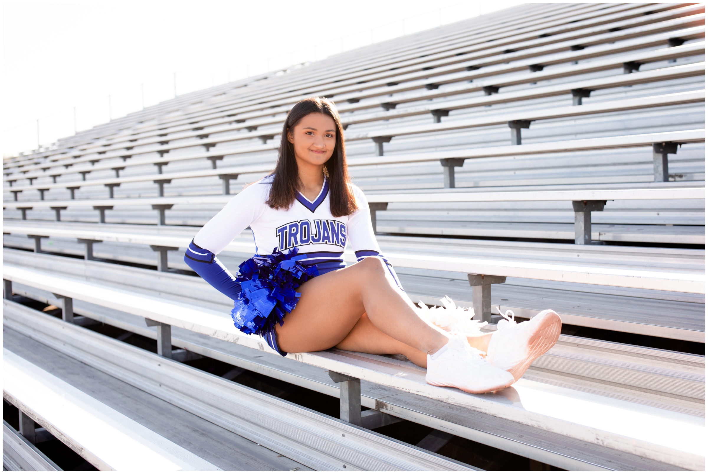 teen girl posing on outdoor bleachers during Longmont High school senior pictures by Colorado photographer Plum Pretty Photos