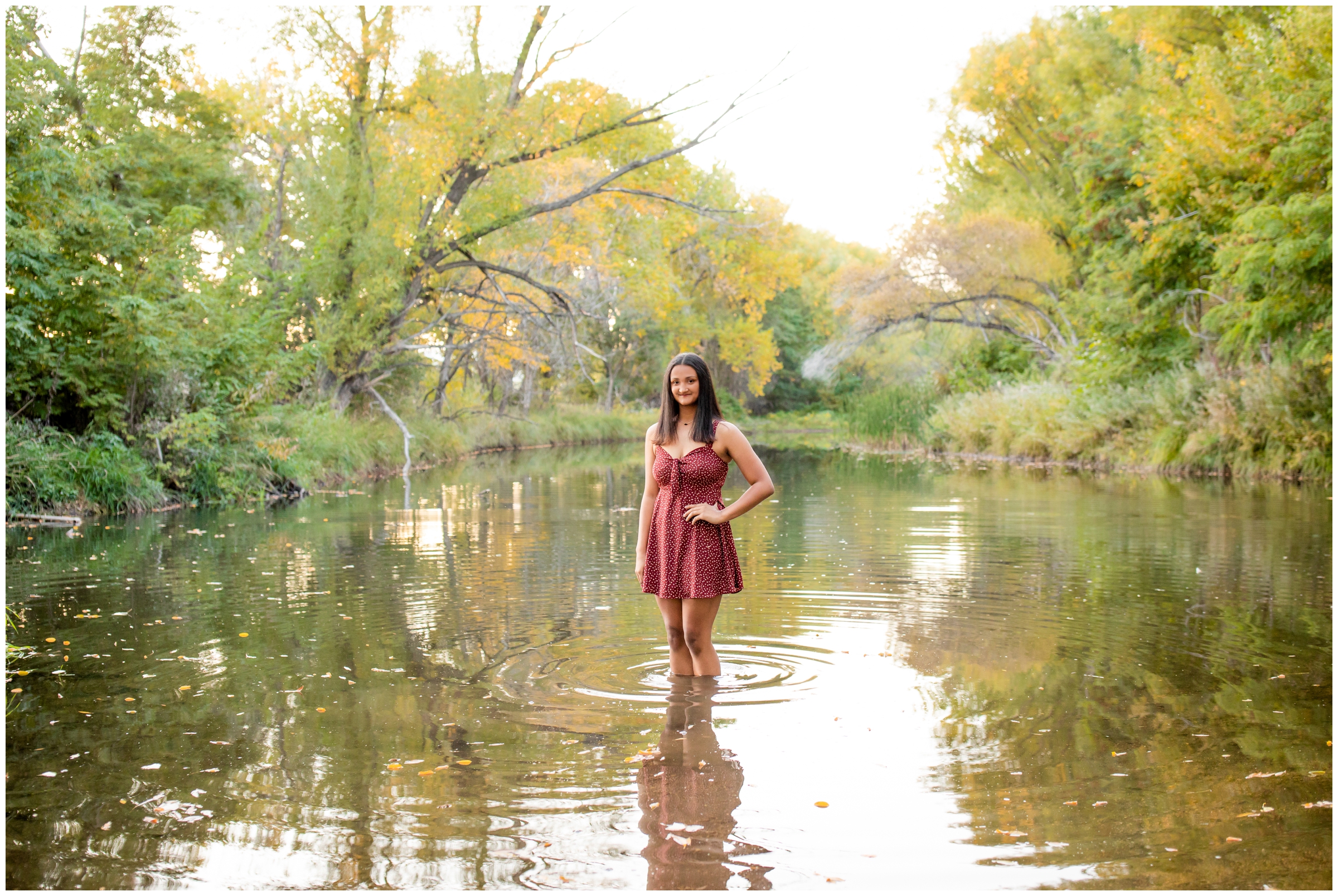 teen posing in pond at Longmont Colorado senior portraits at Golden Ponds 