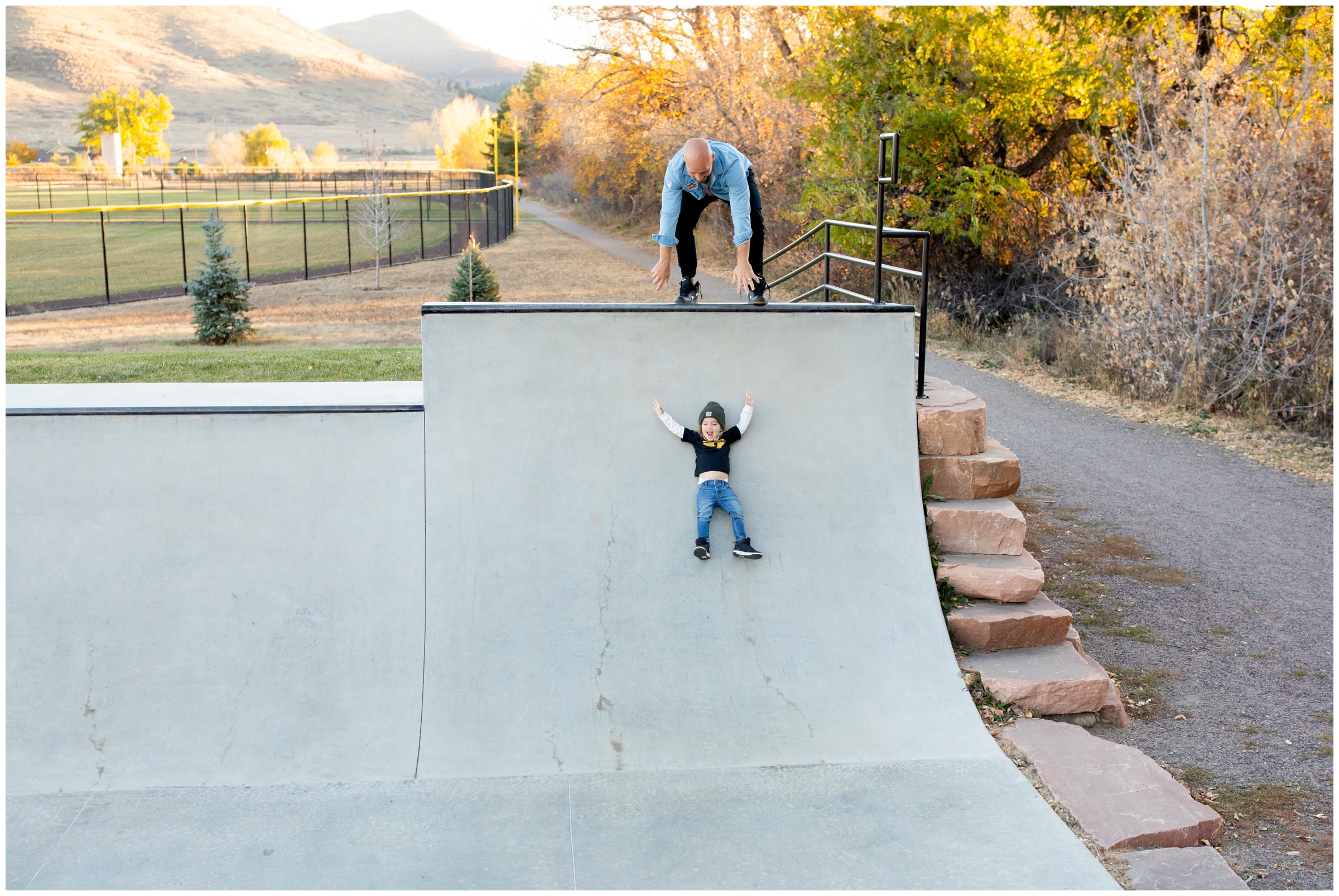 little boy using skate park ramps like a slide at Bohn Park Lyons