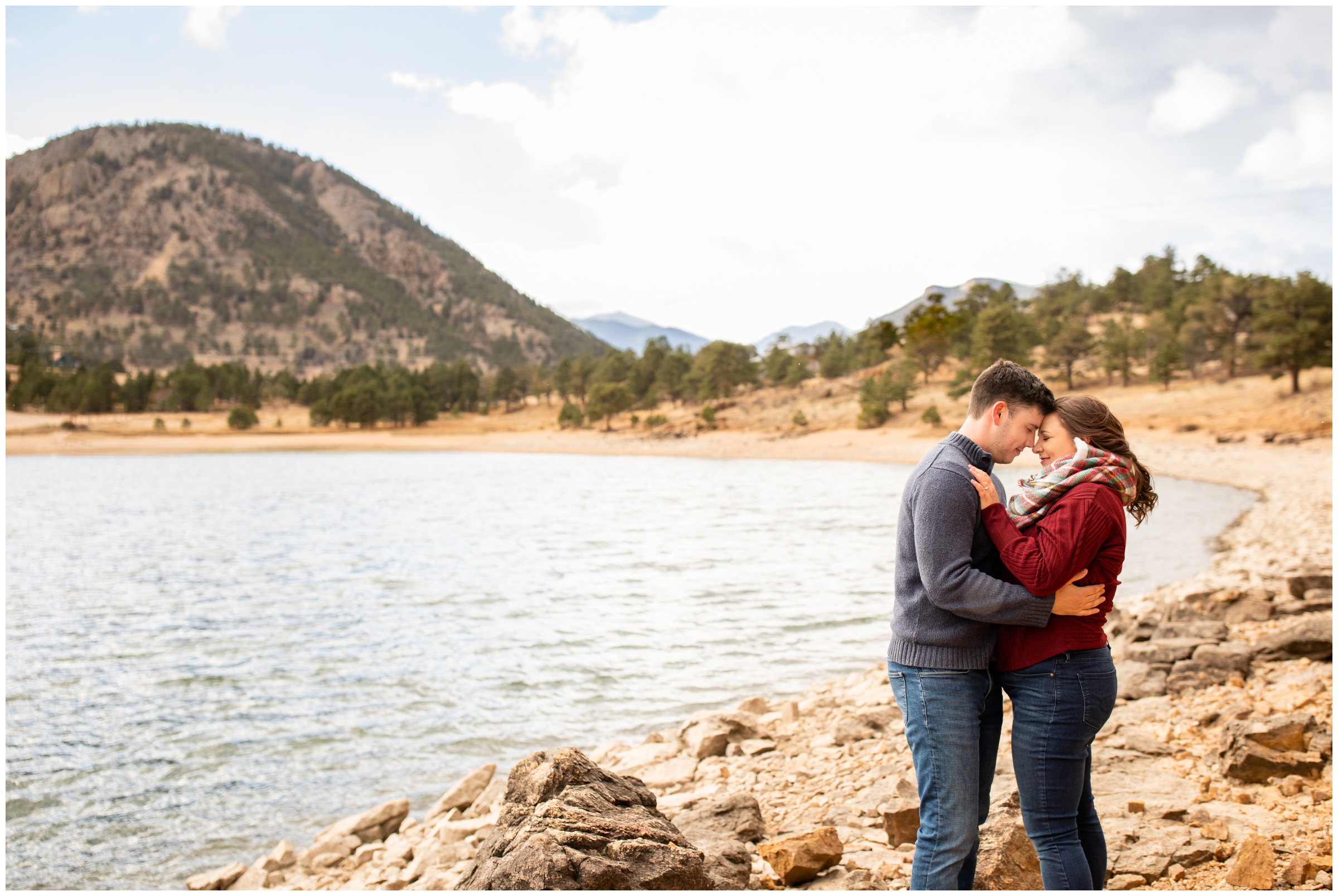 couple cuddling on rock formation during Estes Park engagement photos at Marys Lake