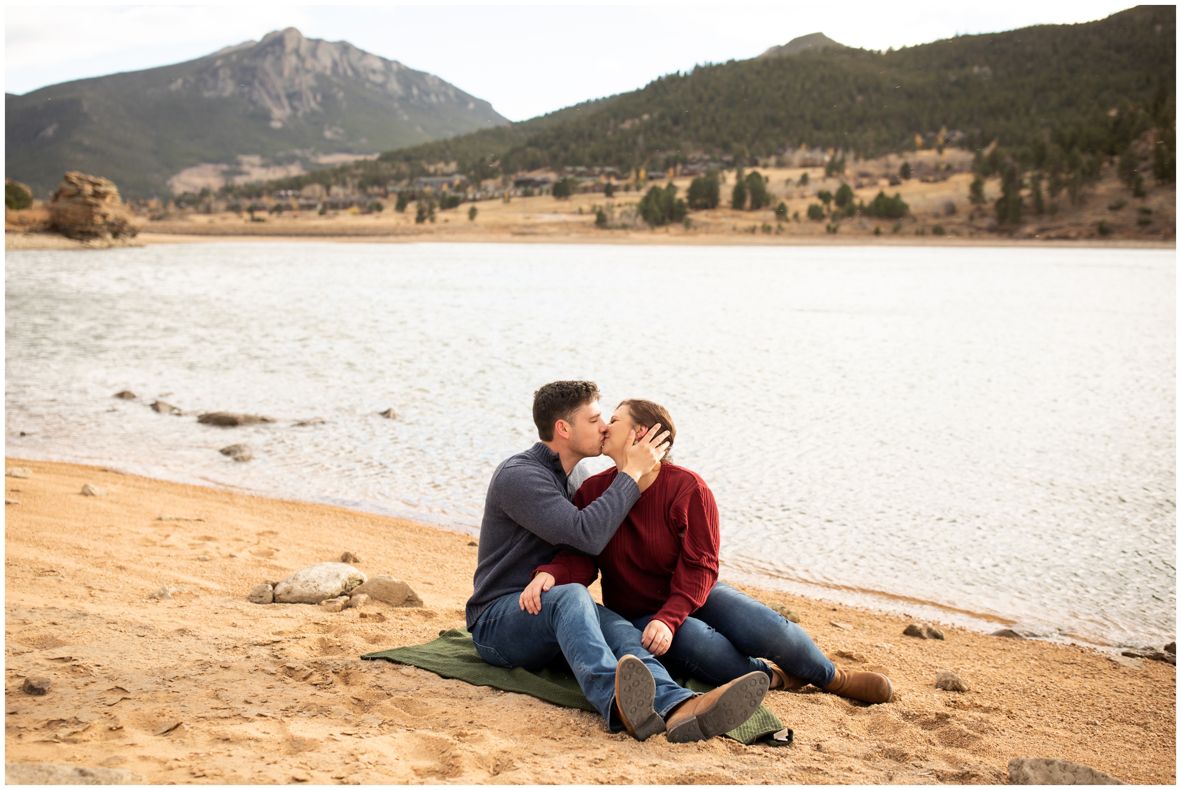 couple kissing next to a mountain lake in Estes Park Colorado