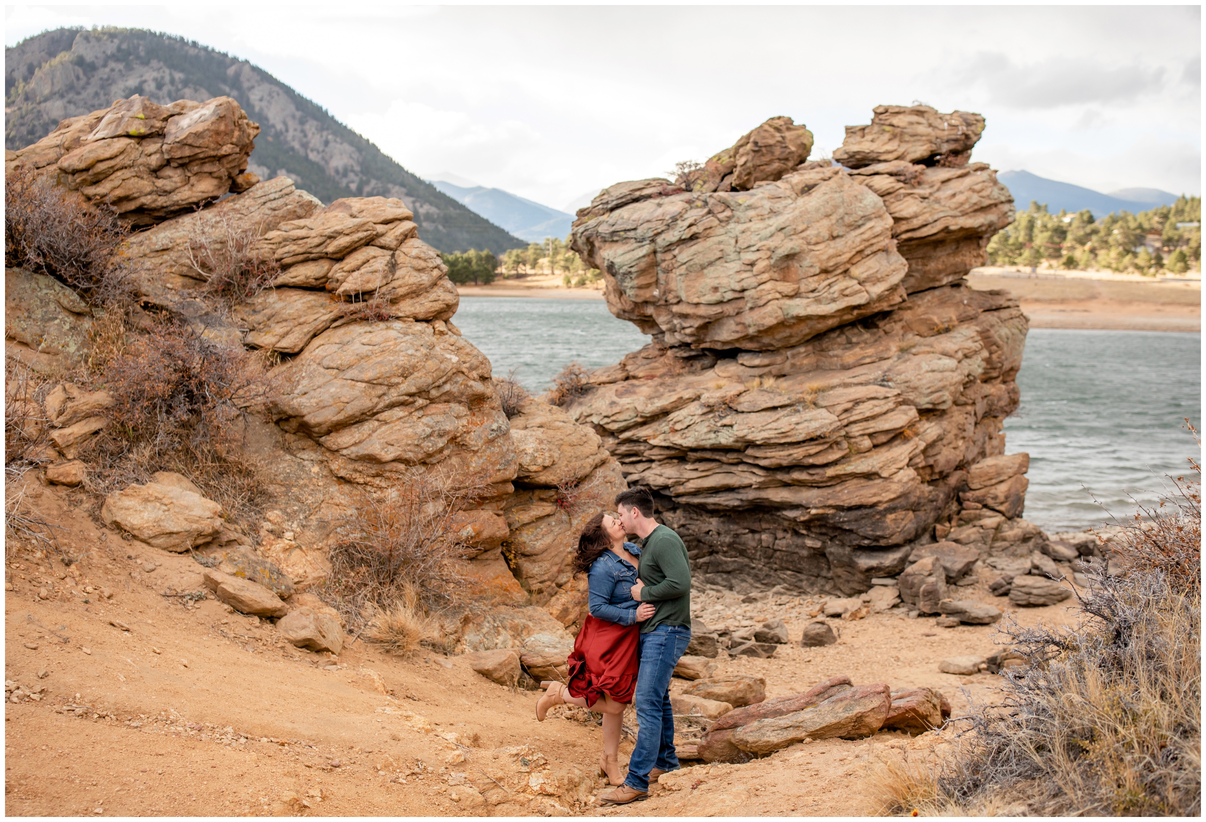couple kissing next to rock formations at Marys Lake Colorado engagement photos