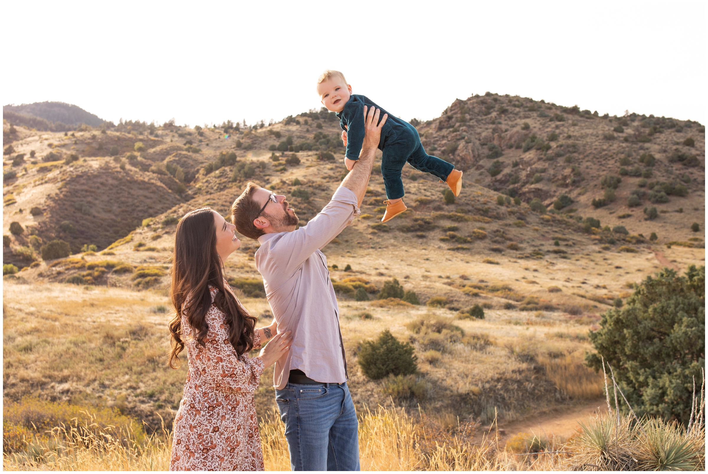 dad lifting baby in the air during Mount Falcon family photography session in Colorado 