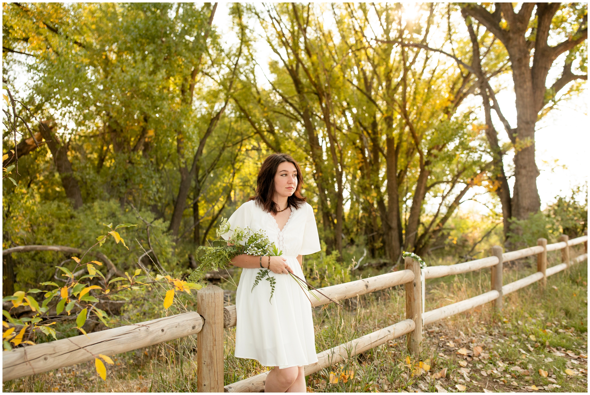 teen holding floral bouquet during boho senior pictures in Longmont Colorado 