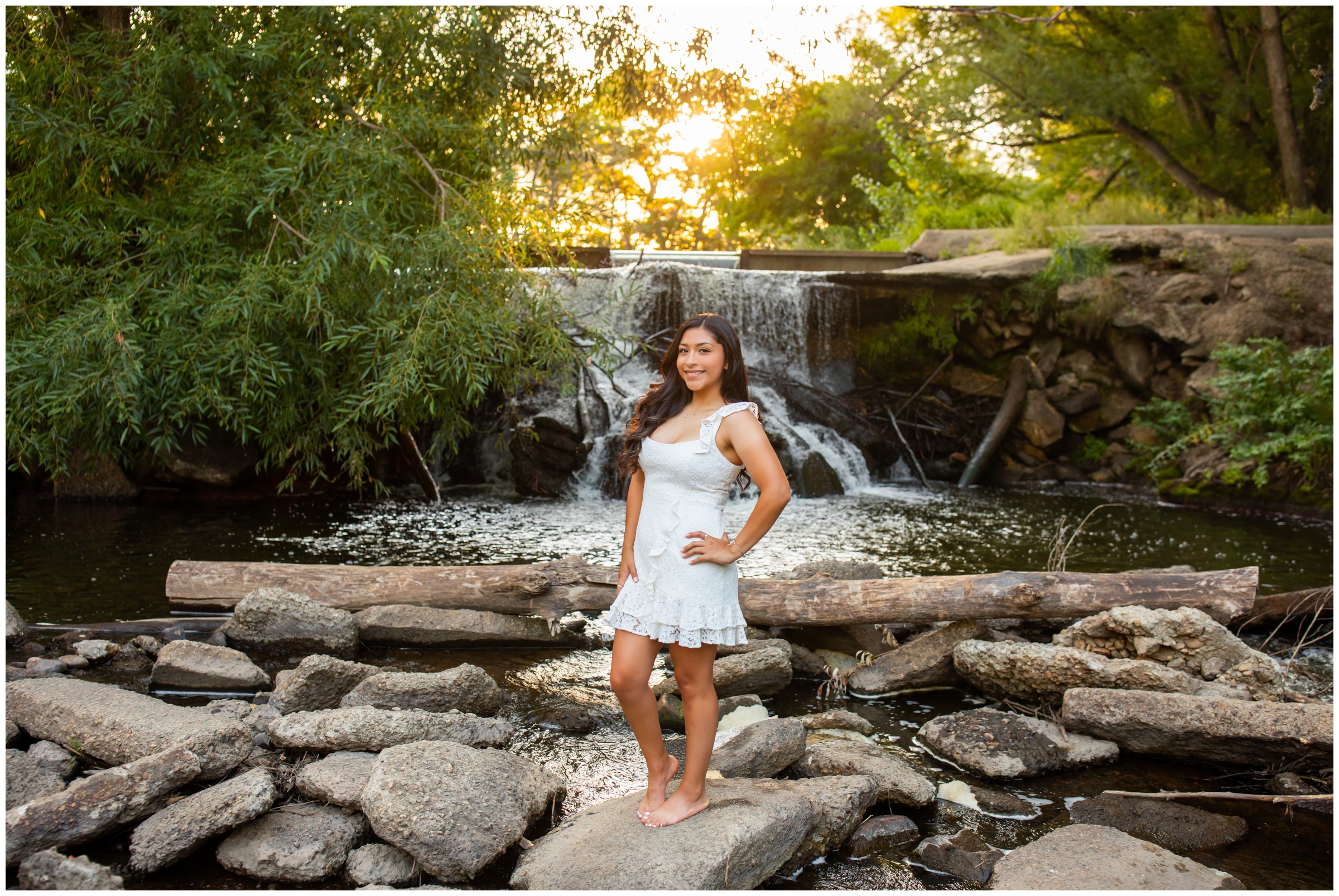 teen girl posing in front of waterfall during Golden Ponds Longmont senior portraits 