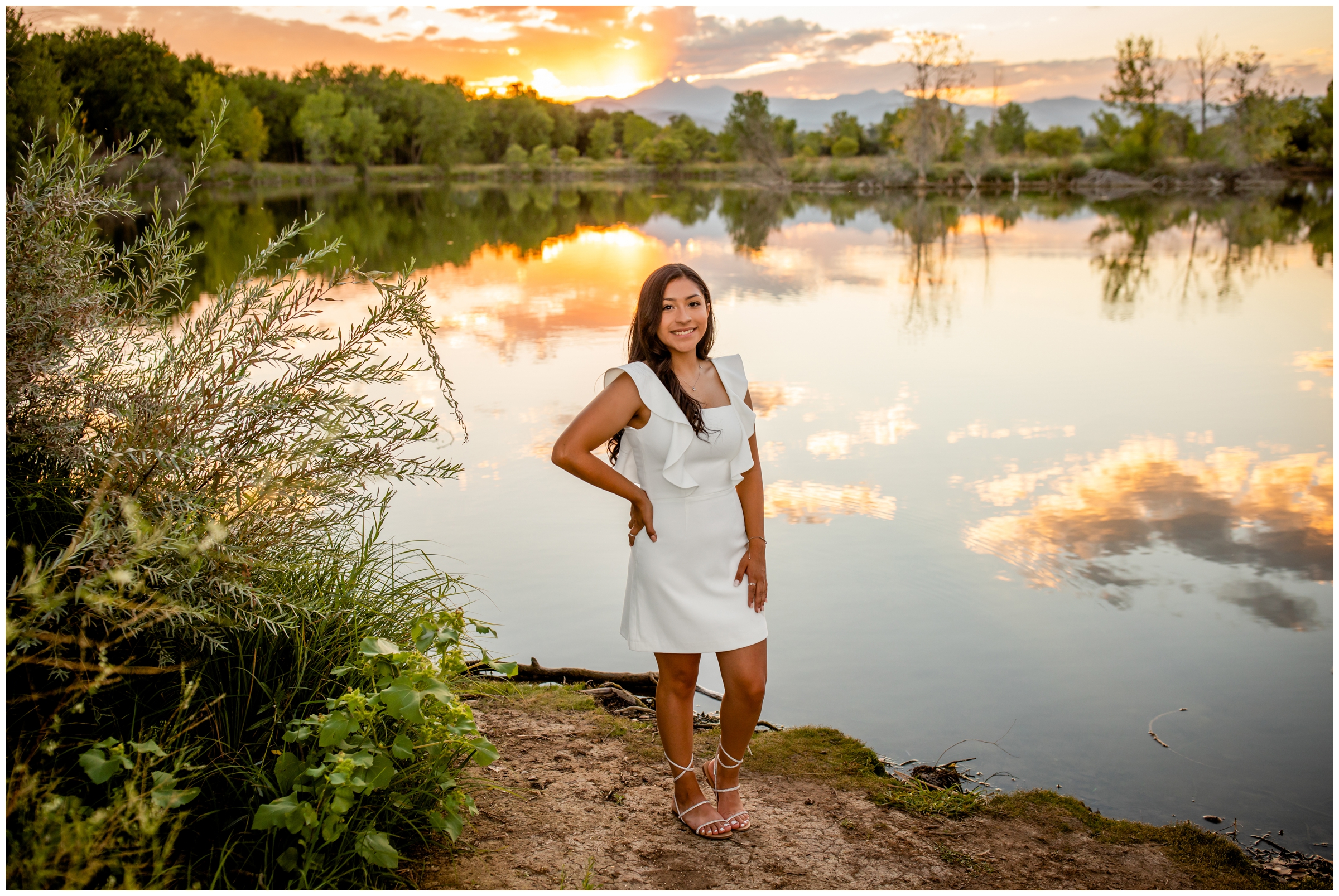 teen girl posing by a lake at sunset during Longmont Colorado senior photography session