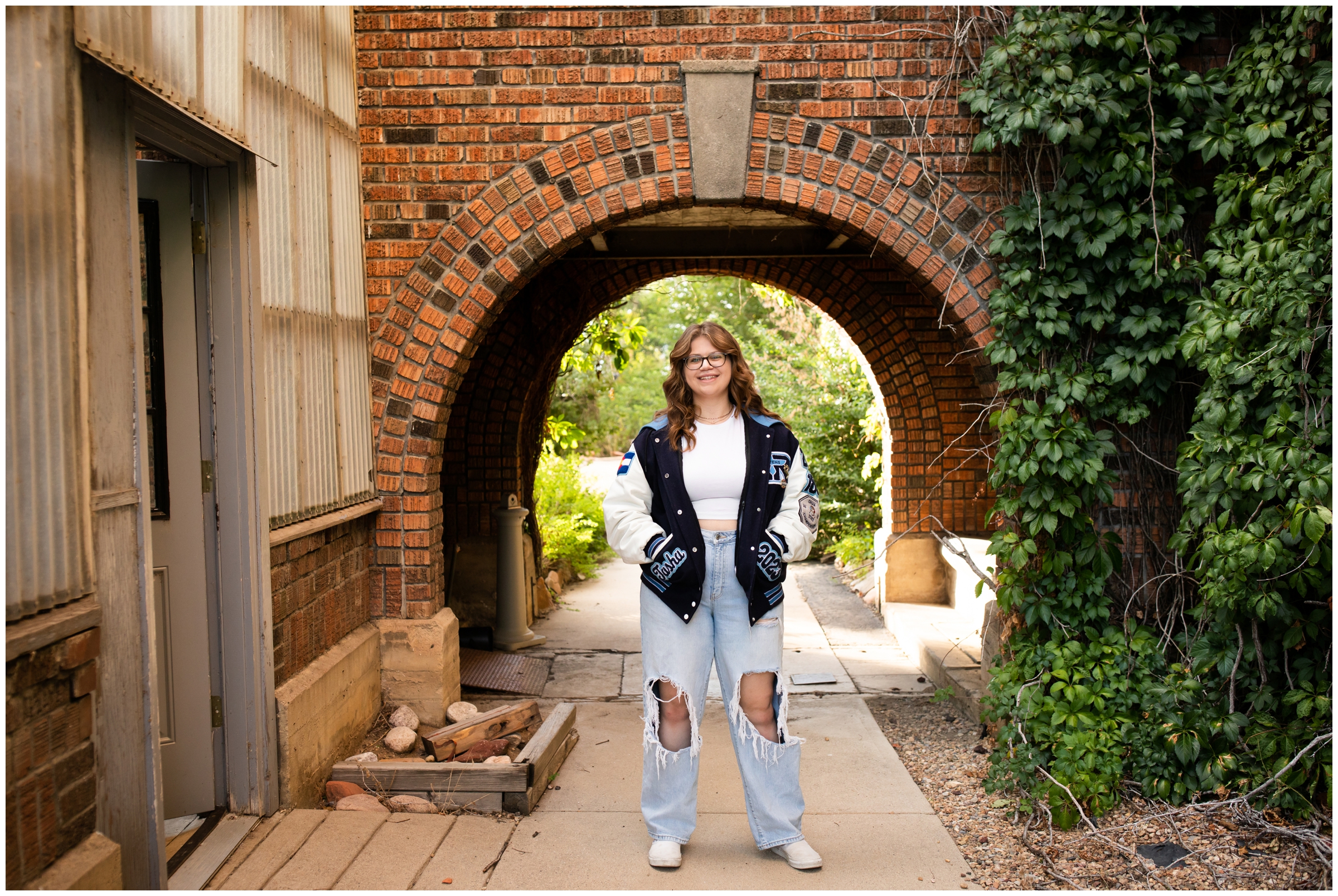 teen posing under a brick arch during Boulder Colorado senior photography session 