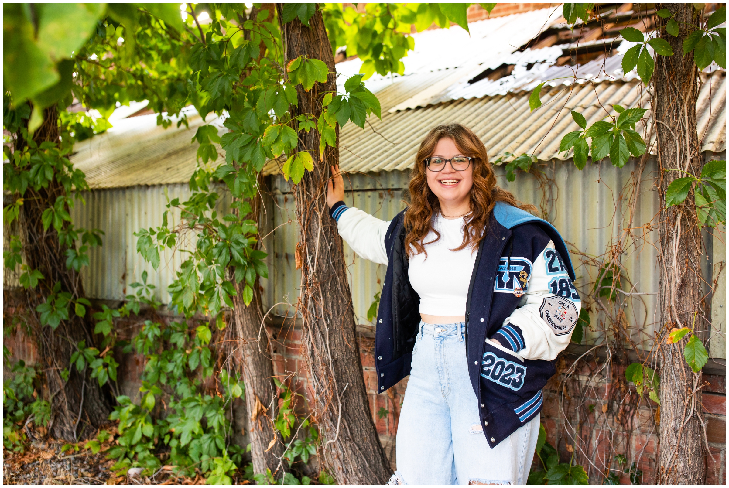 teen girl leaning against a tree during Boulder Colorado senior pictures by Plum Pretty Photography