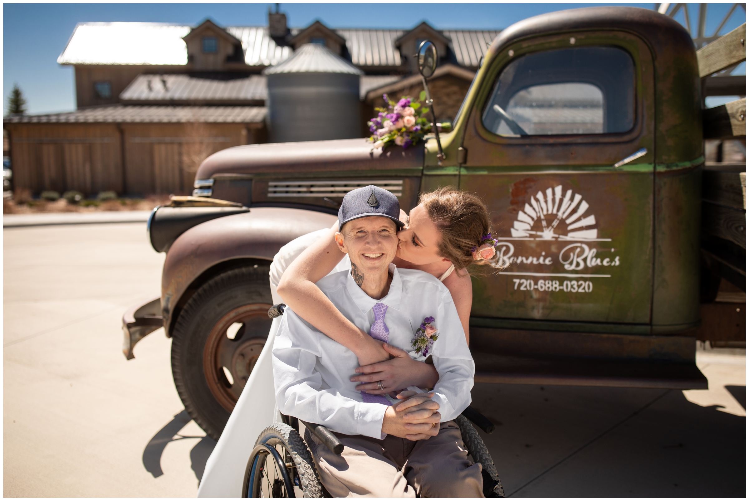 bride kissing her groom in front of rustic truck at Bonnie Blues Event Venue in Elizabeth Colorado during spring micro wedding