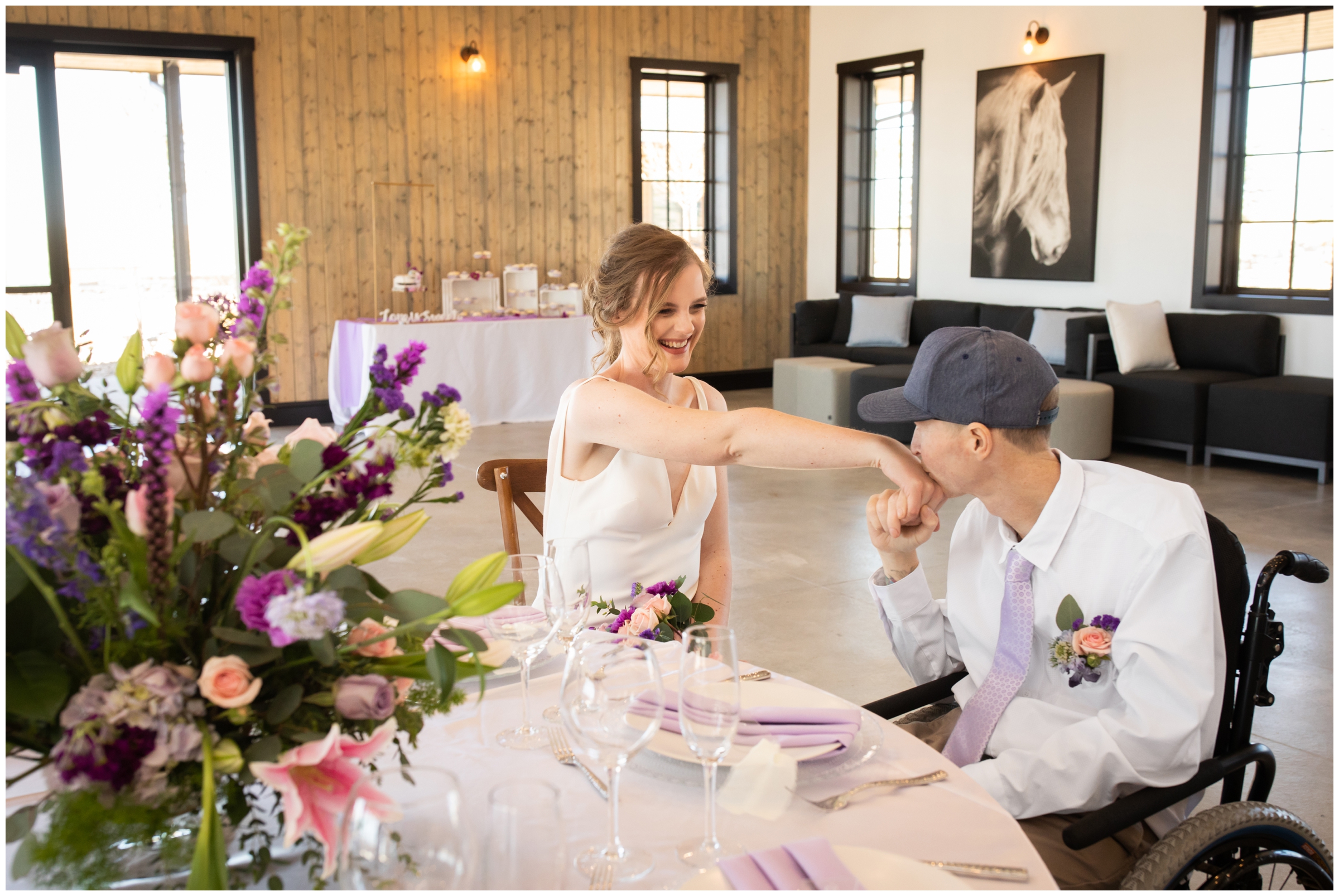 groom kissing bride's hand during spring wedding reception in Elizabeth Colorado
