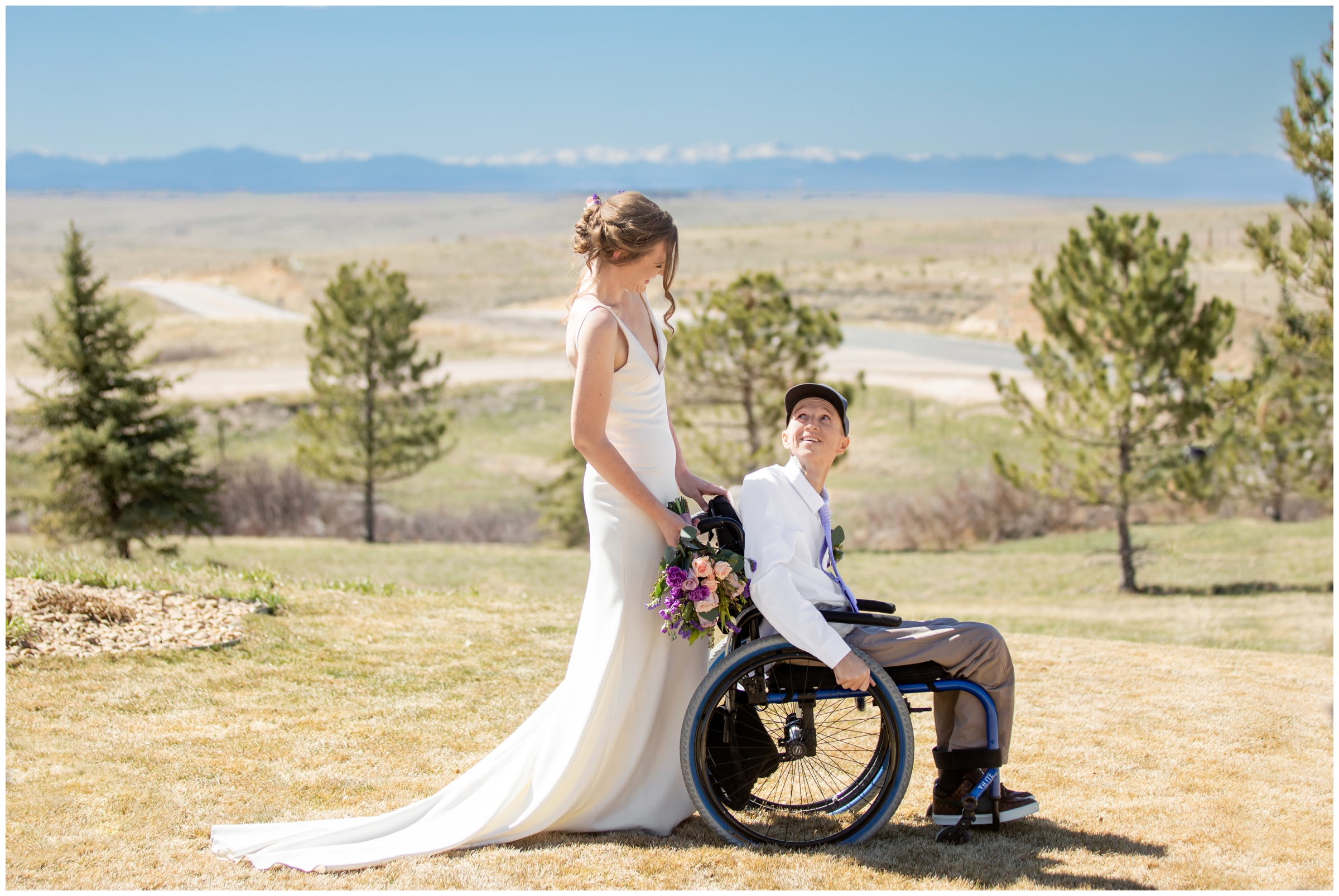 bride pushing groom in wheelchair during spring wedding portraits in Elizabeth Colorado 