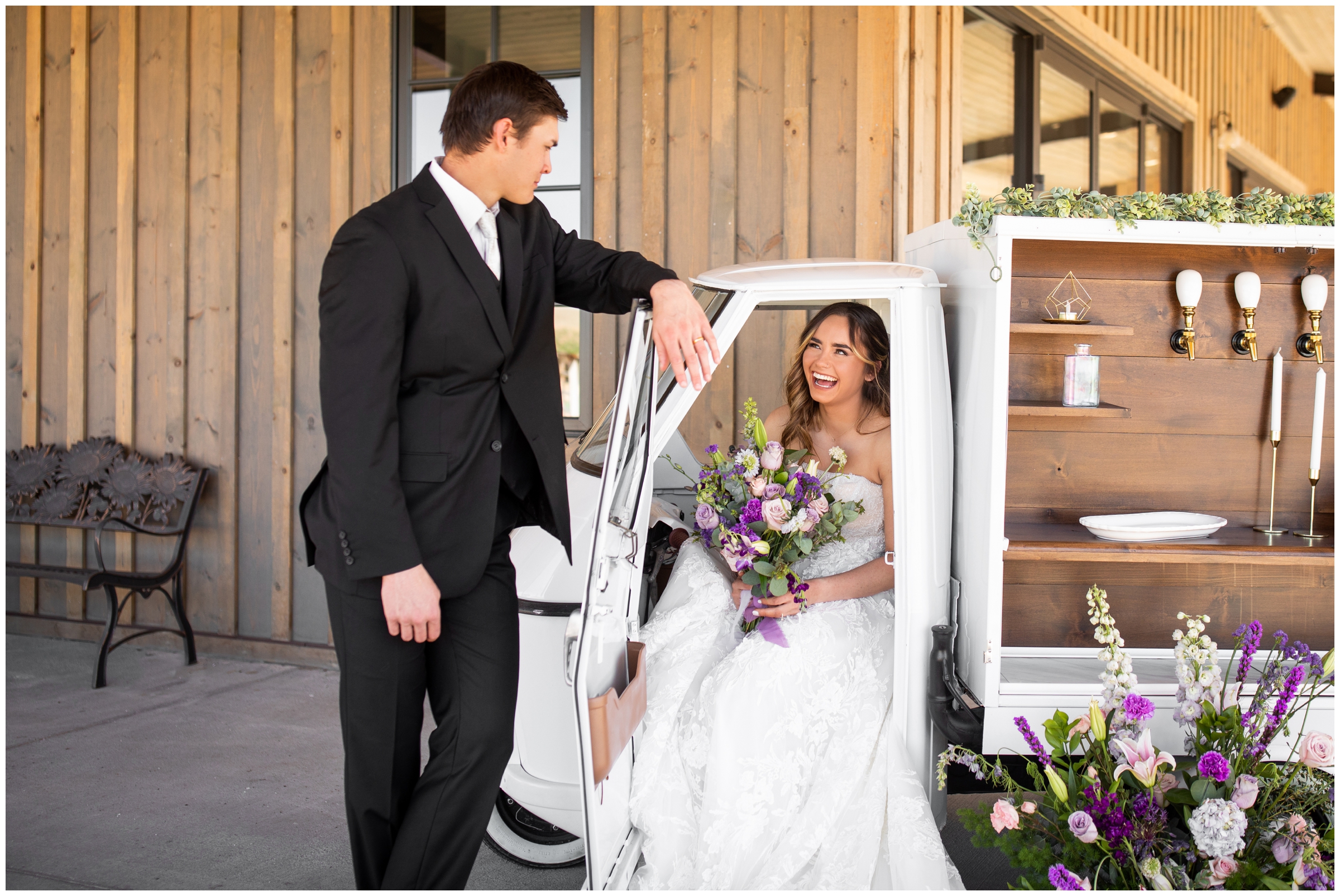 couple posing in La Piccolina mobile bar cart during Bonnie Blues Colorado wedding photos by Plum Pretty Photography