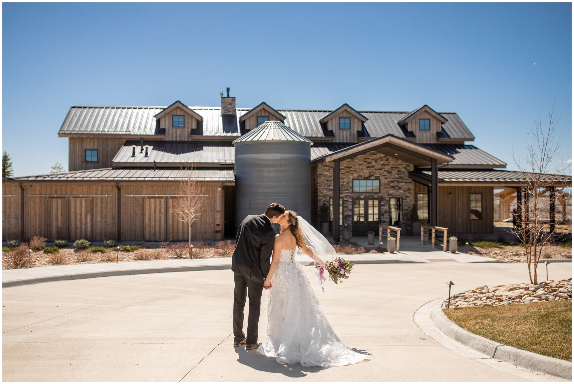 couple kissing in front of venue during spring wedding portraits at Bonnie Blues Event Center