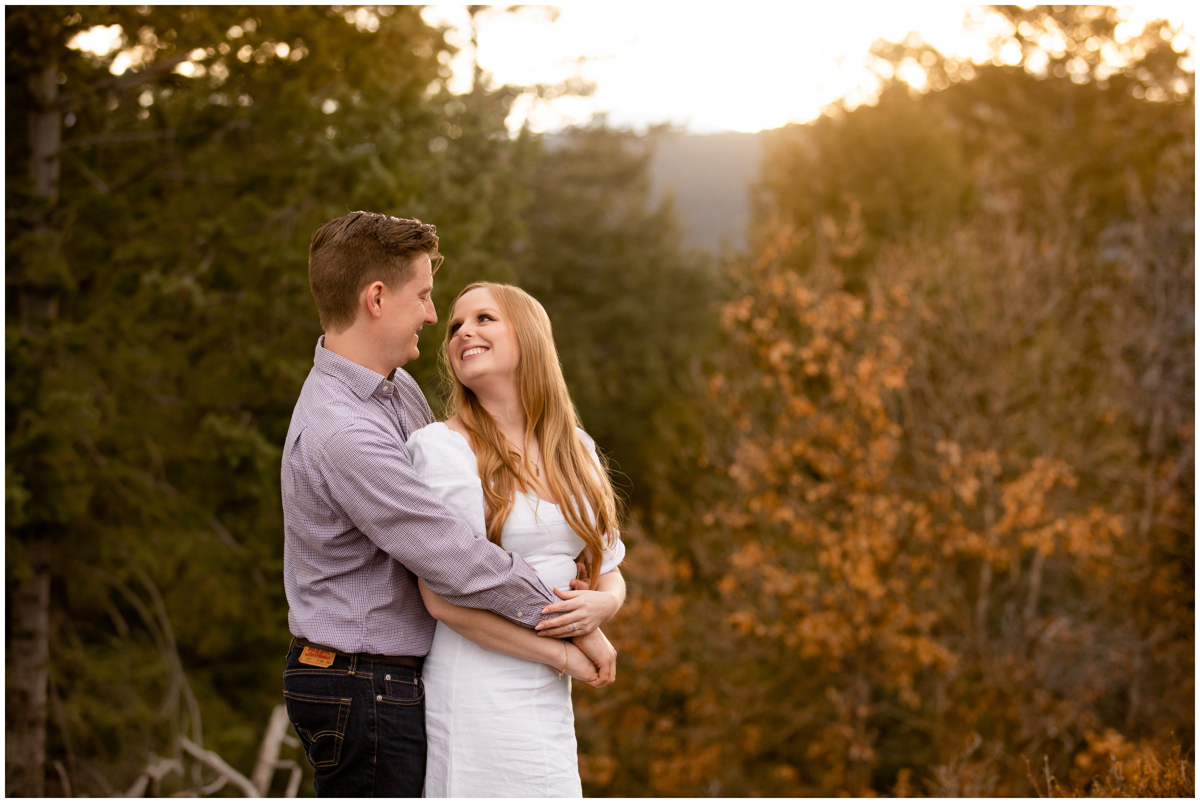 couple cuddling in the mountains during golden hour at Mount Falcon Park Colorado anniversary photo session 