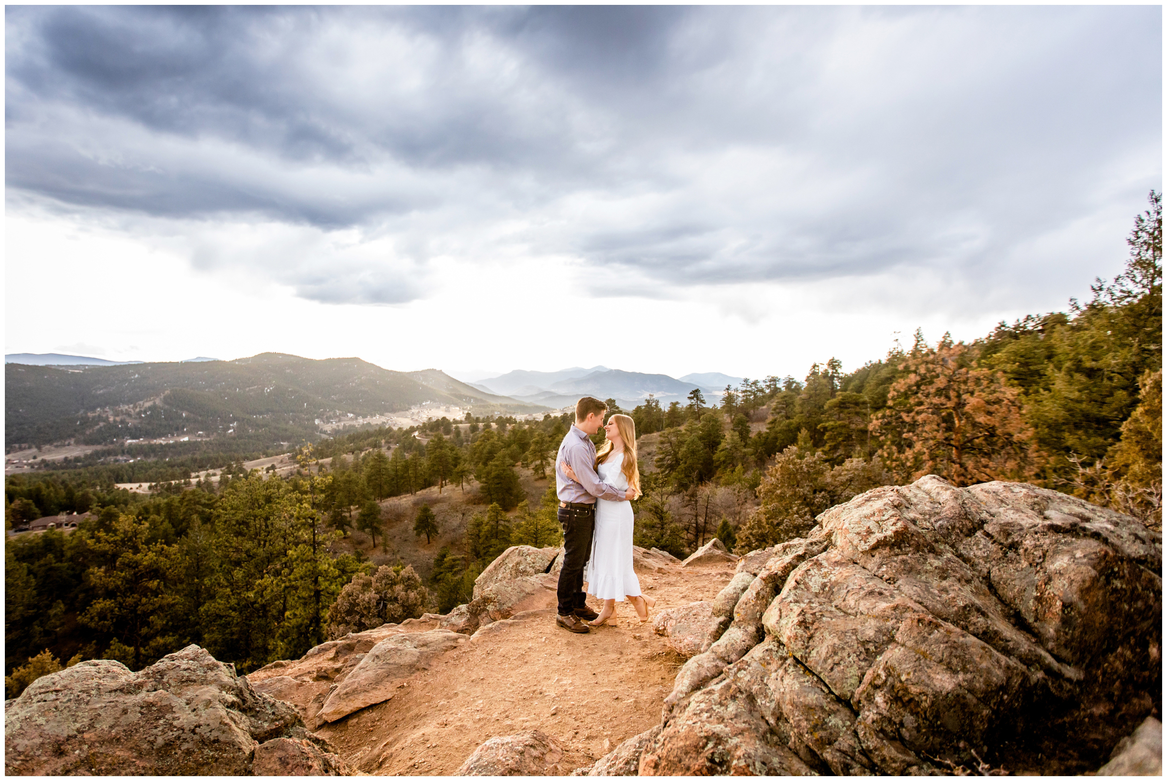 couple posing on a mountaintop in the Colorado mountains during anniversary portraits by Plum Pretty Photography