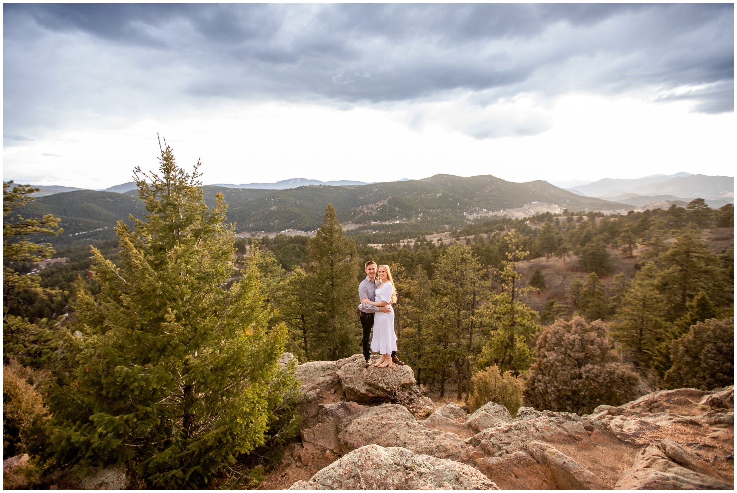 couple posing on rock formations in the mountains during couples photography session at Mount Falcon Park in Colorado 