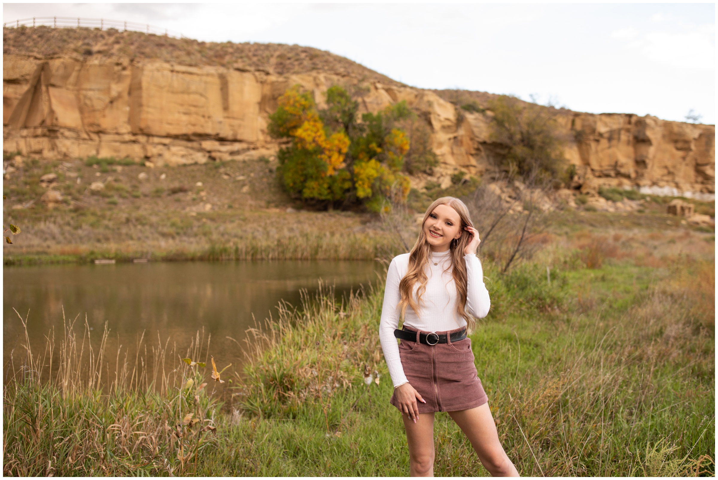 teen posing in front of rocky cliffs during Sandstone Ranch Longmont graduation photography session 