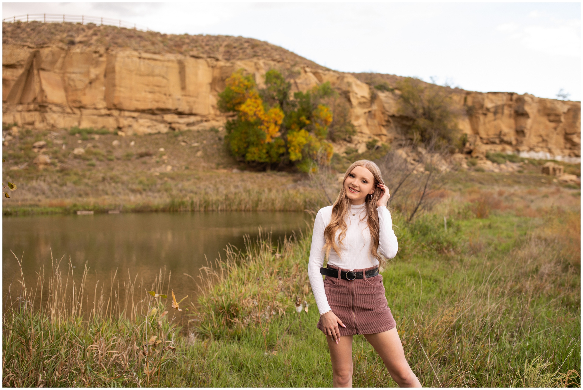 teen posing in front of rocky cliffs during Sandstone Ranch Longmont graduation photography session