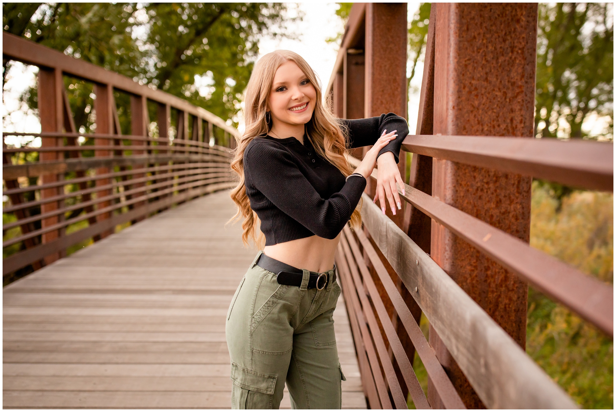 teen posing on bridge at Sandstone Ranch in Longmont during high school senior photography session in Colorado