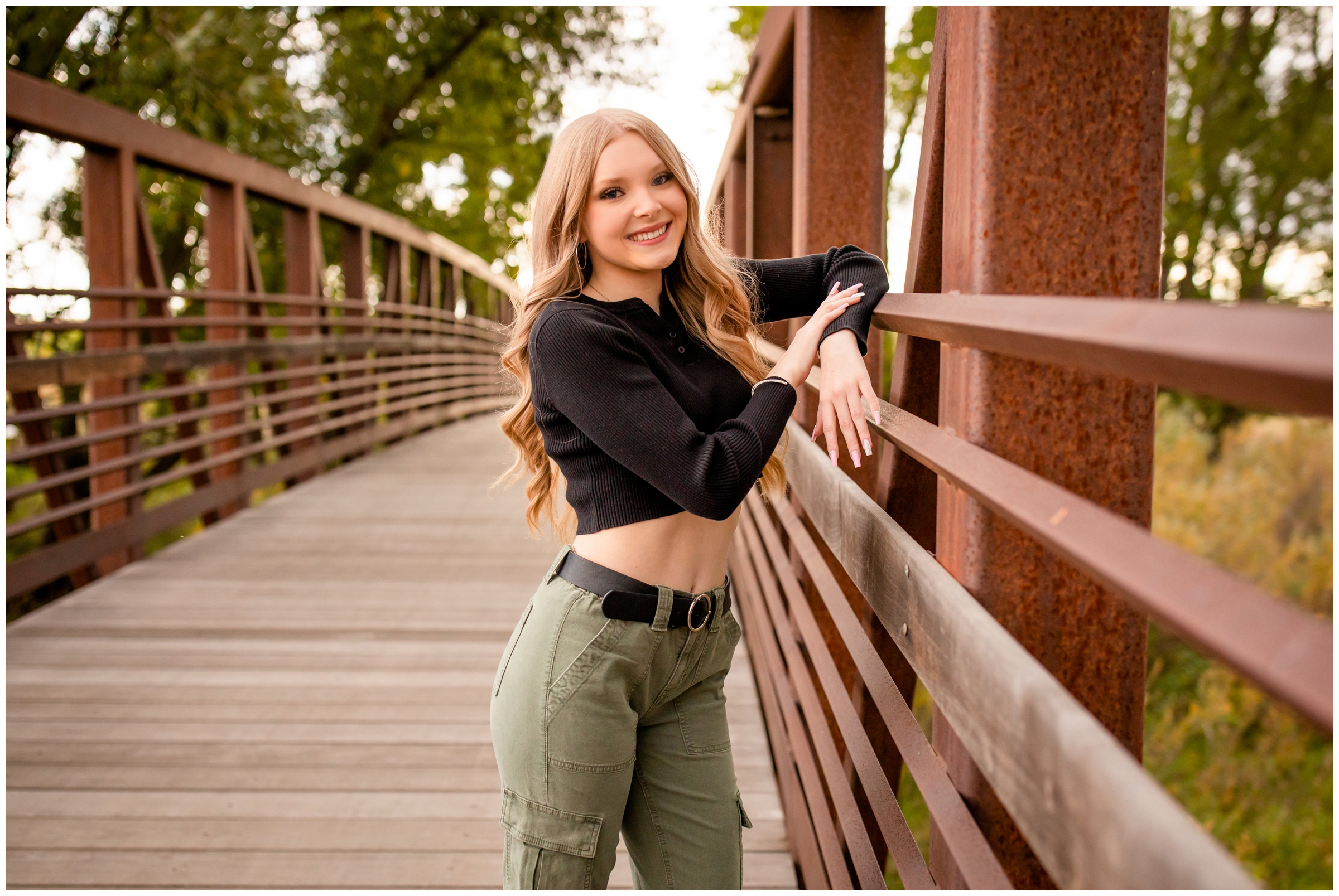 teen posing on bridge at Sandstone Ranch in Longmont during high school senior photography session in Colorado 