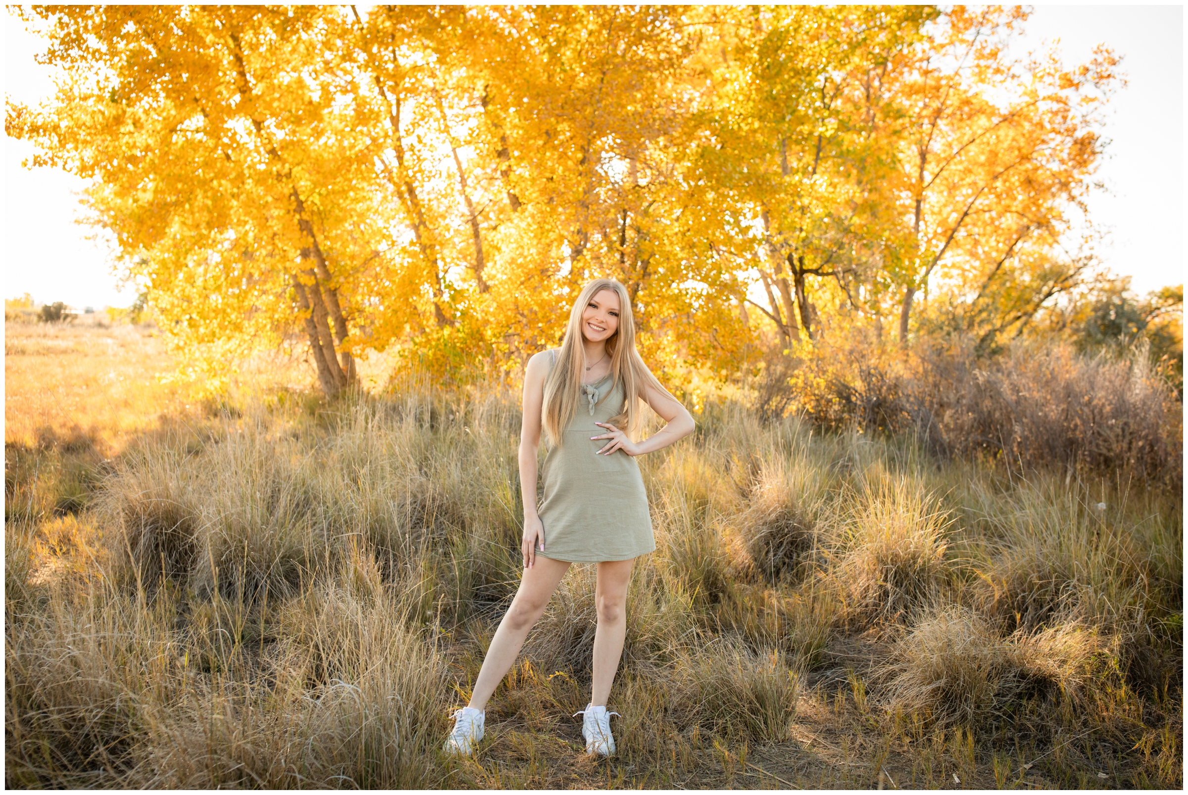 teen girl posing in front of colorful fall foliage during Colorado senior pictures at Idaho Creek Open Space in Longmont 