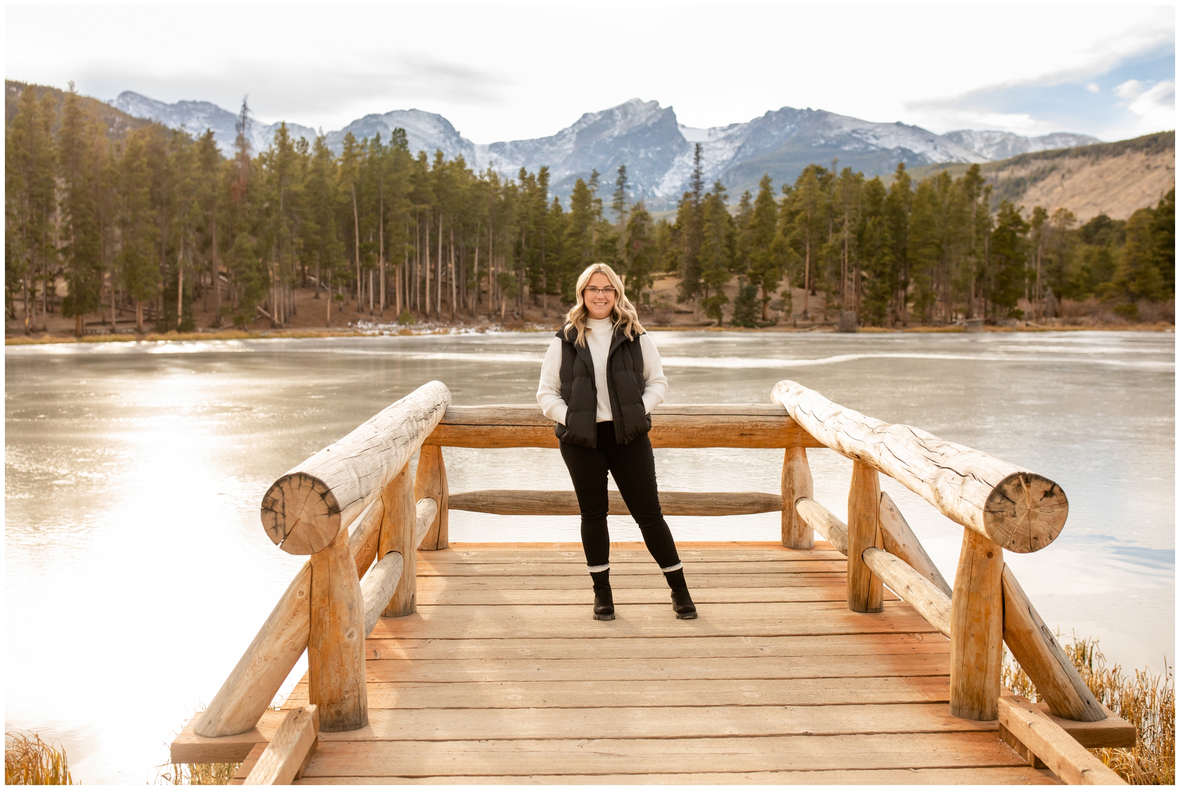 teen posing on wooden dock at Sprague Lake during Colorado mountain senior pictures in RMNP