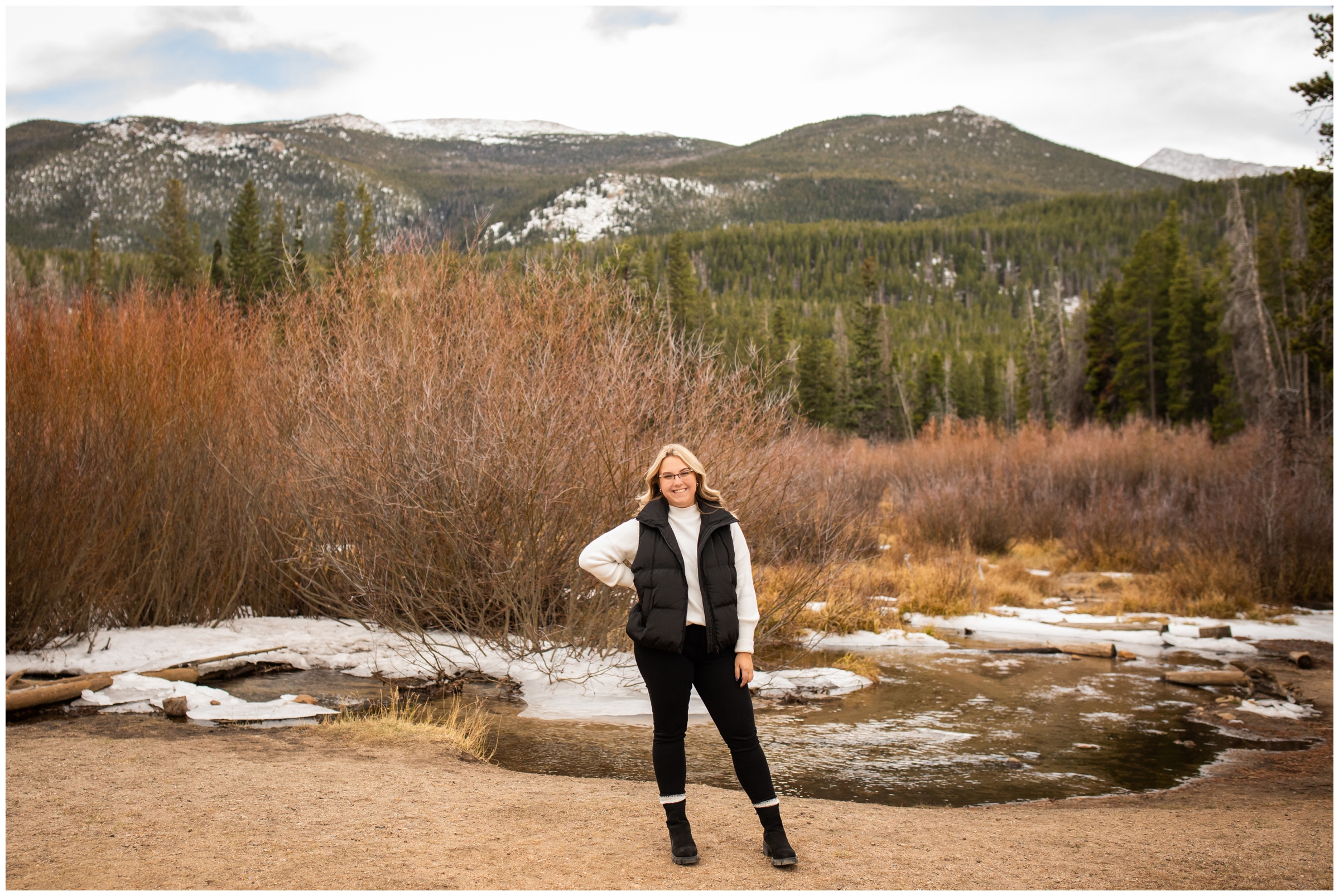 teen posing in front of river during mountain senior photos in Estes Park Colorado 