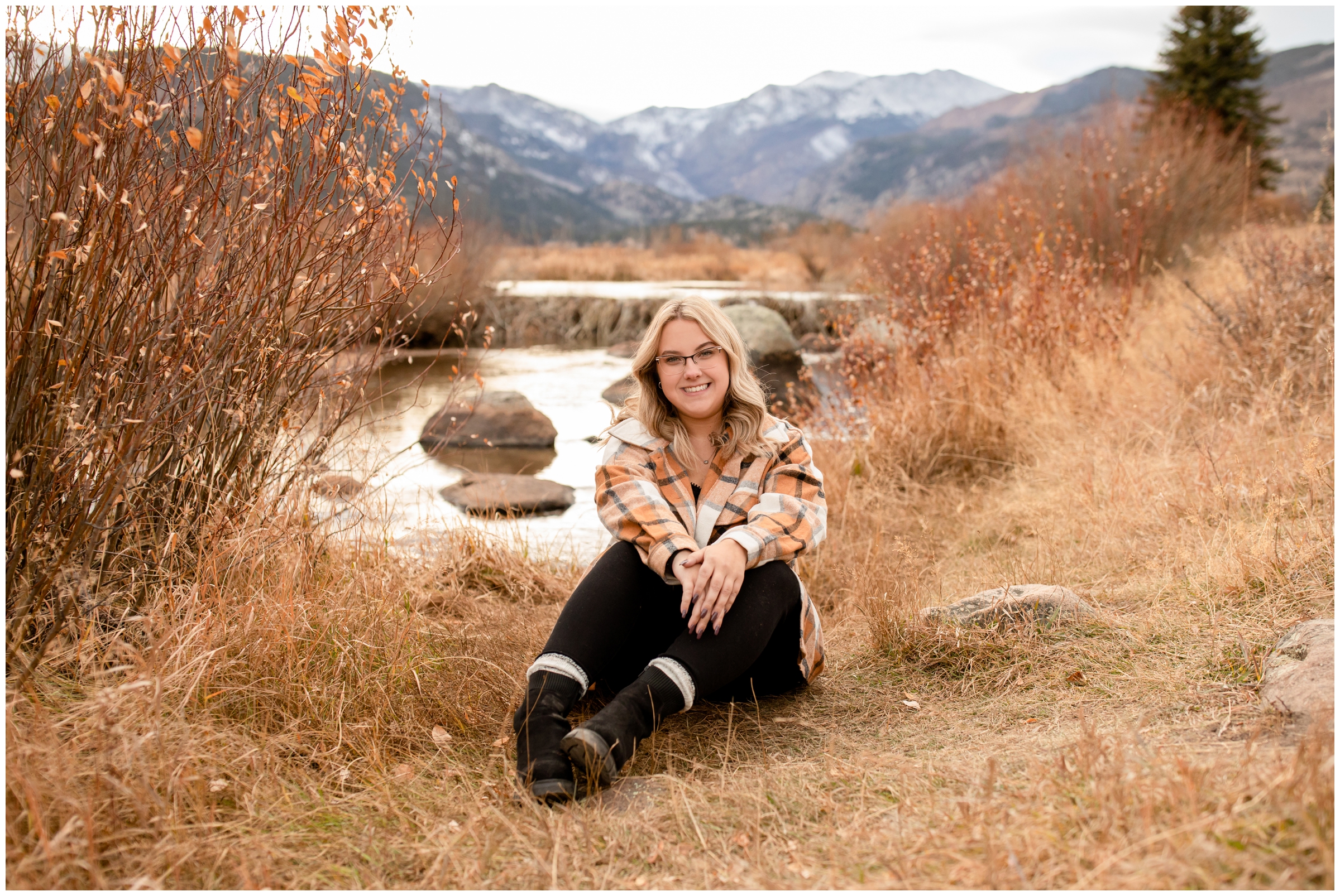 teen sitting in front of mountain river during Rocky Mountain National Park Colorado senior portraits