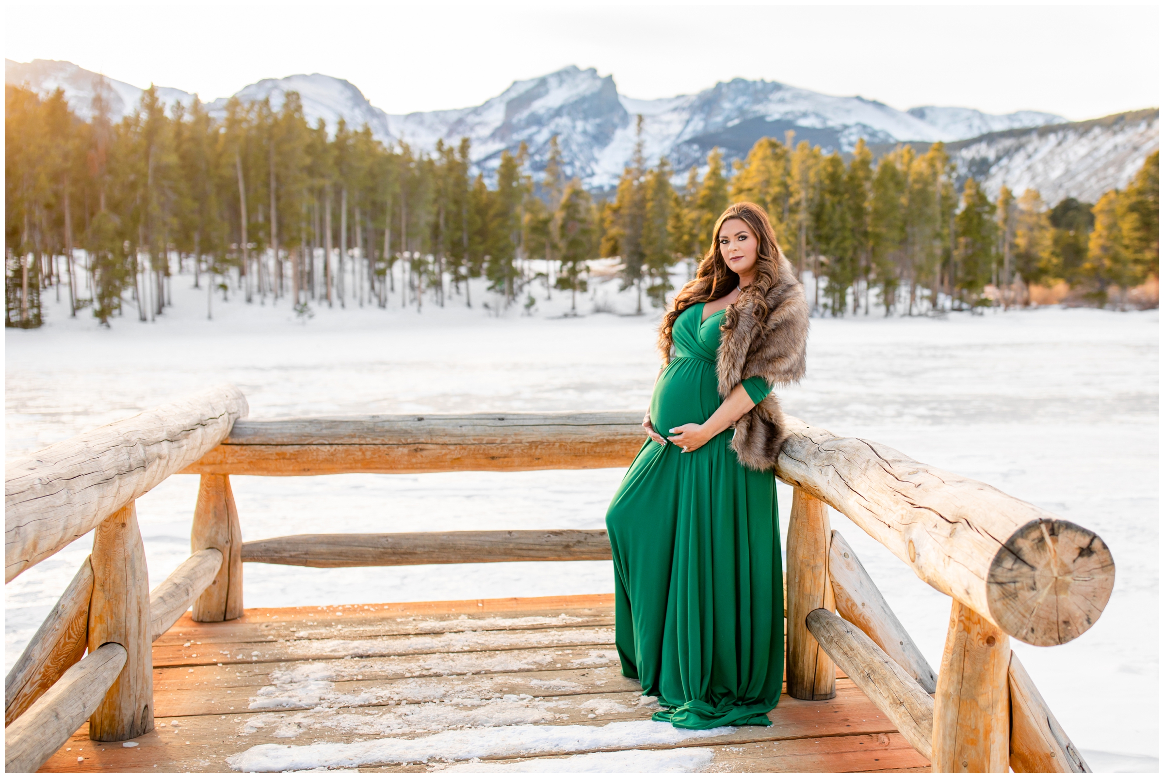 pregnant woman posing on dock during Sprague Lake RMNP winter maternity photos