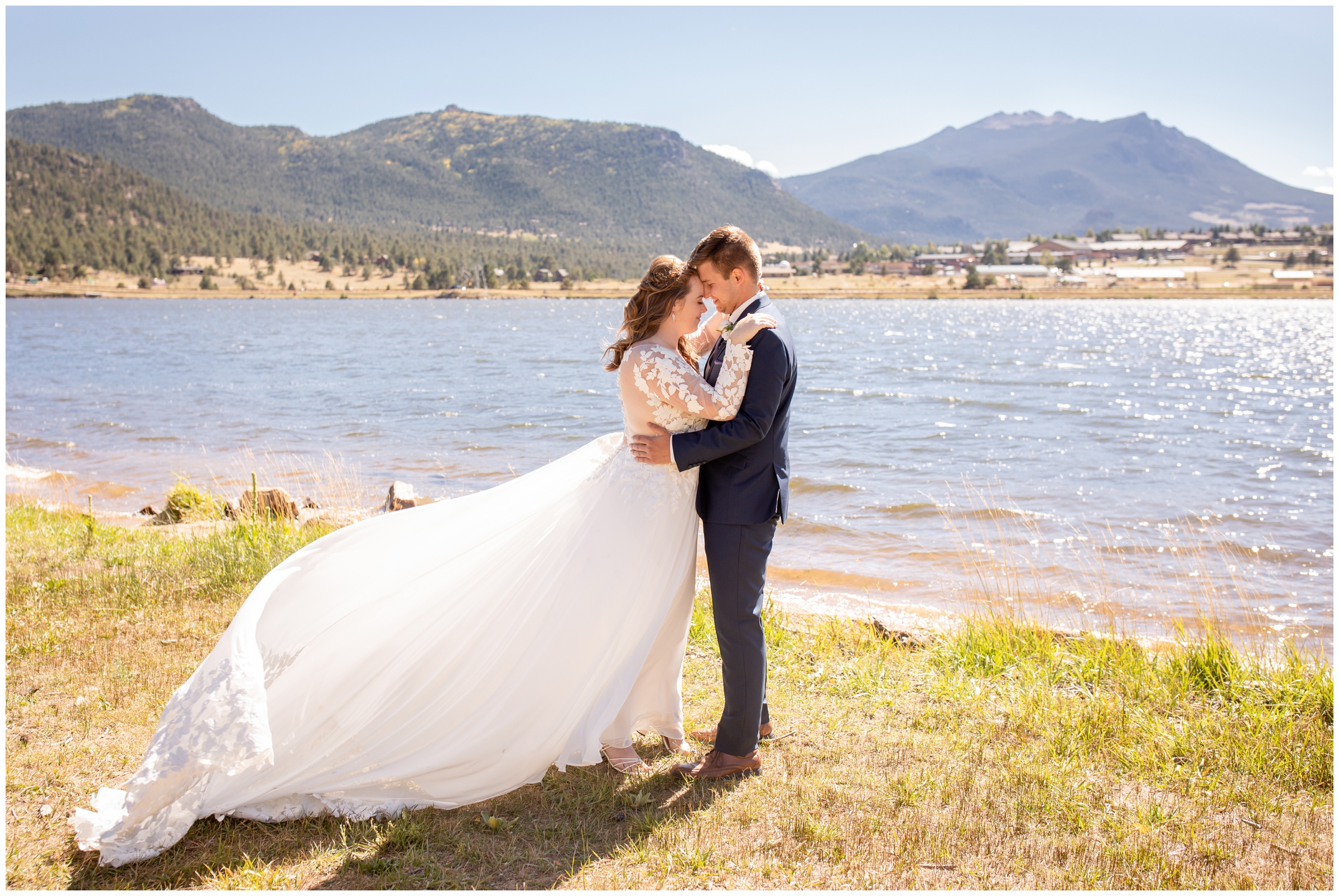 couple embracing next to Lake Estes during fall wedding portraits in the Colorado mountains 