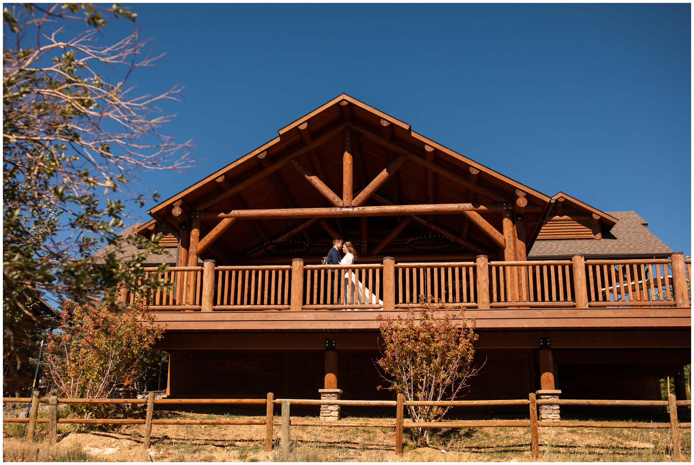 couple posing on balcony of cabin during Estes Park elopement wedding portraits at Lake Estes 