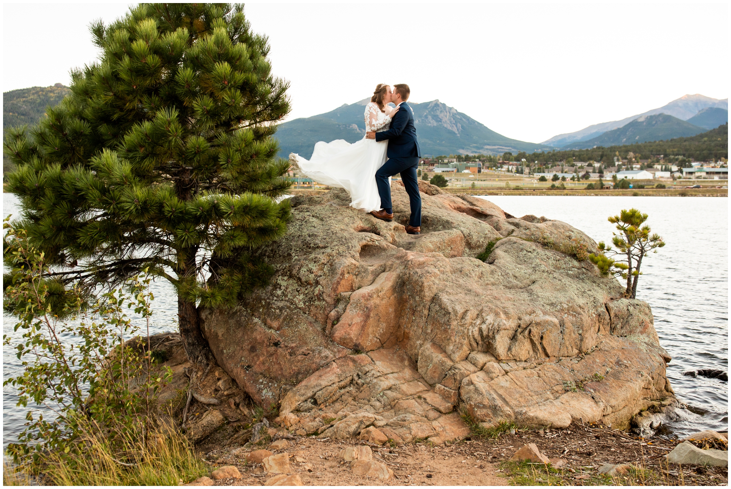 couple posing on giant boulder during Estes Park Resort wedding photos in the Colorado mountains 