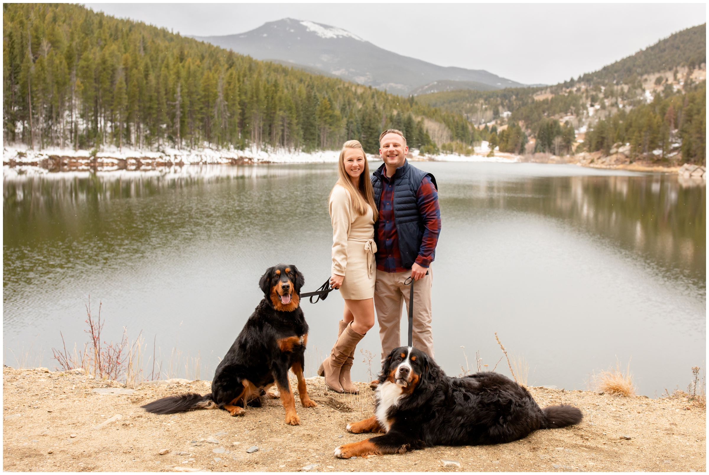 couple posing at mountain lake with their dogs during Evergreen Colorado couples photos by Plum Pretty Photography