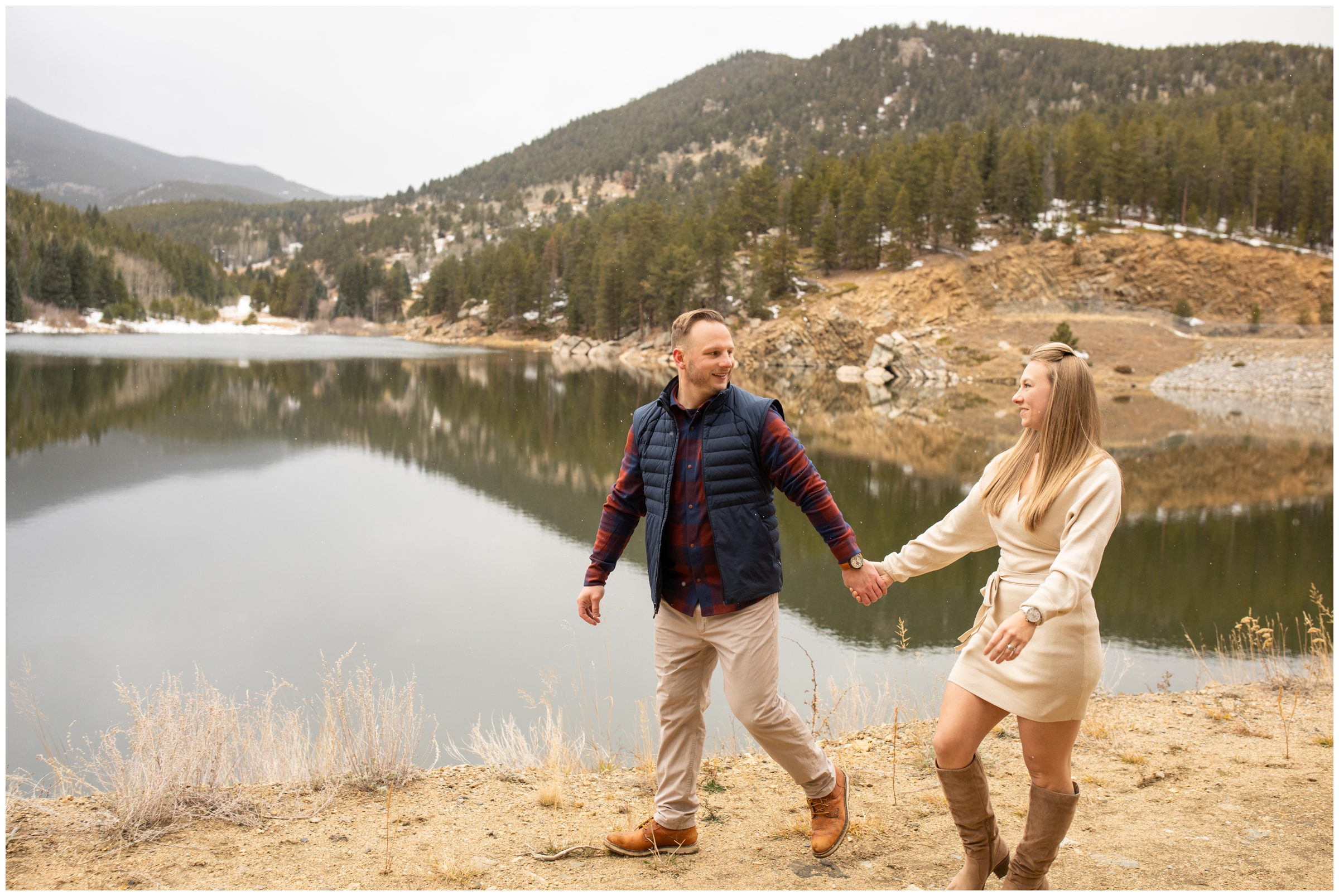 married couple holding hands and walking during anniversary photos at a Colorado mountain lake 