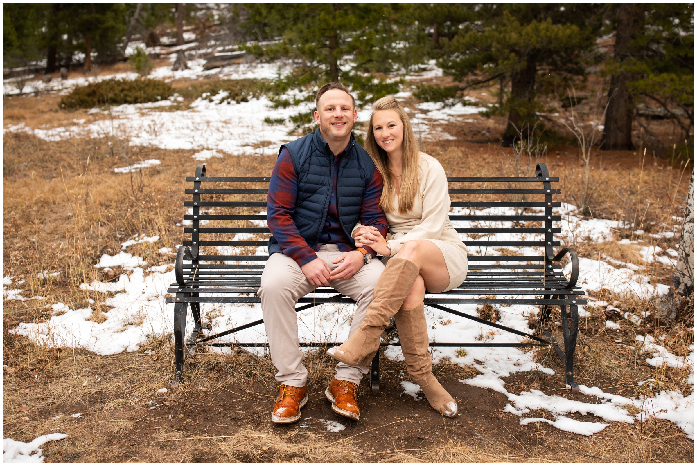 couple sitting on a bench in Evergreen Colorado during snowy fall photography session