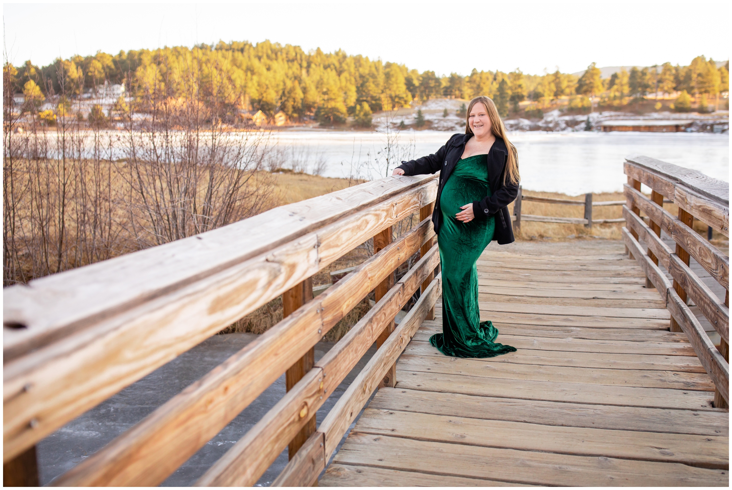 pregnant woman posing on wooden bridge during Colorado mountain maternity pictures during winter 