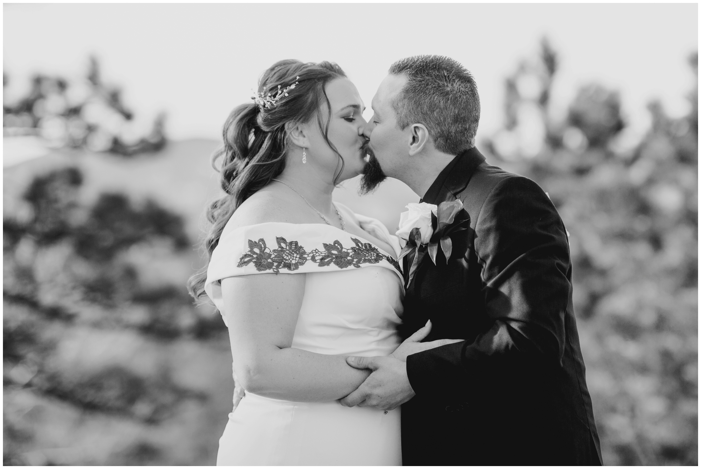 black and white photo of couple kissing during Colorado wedding portraits in Lyons