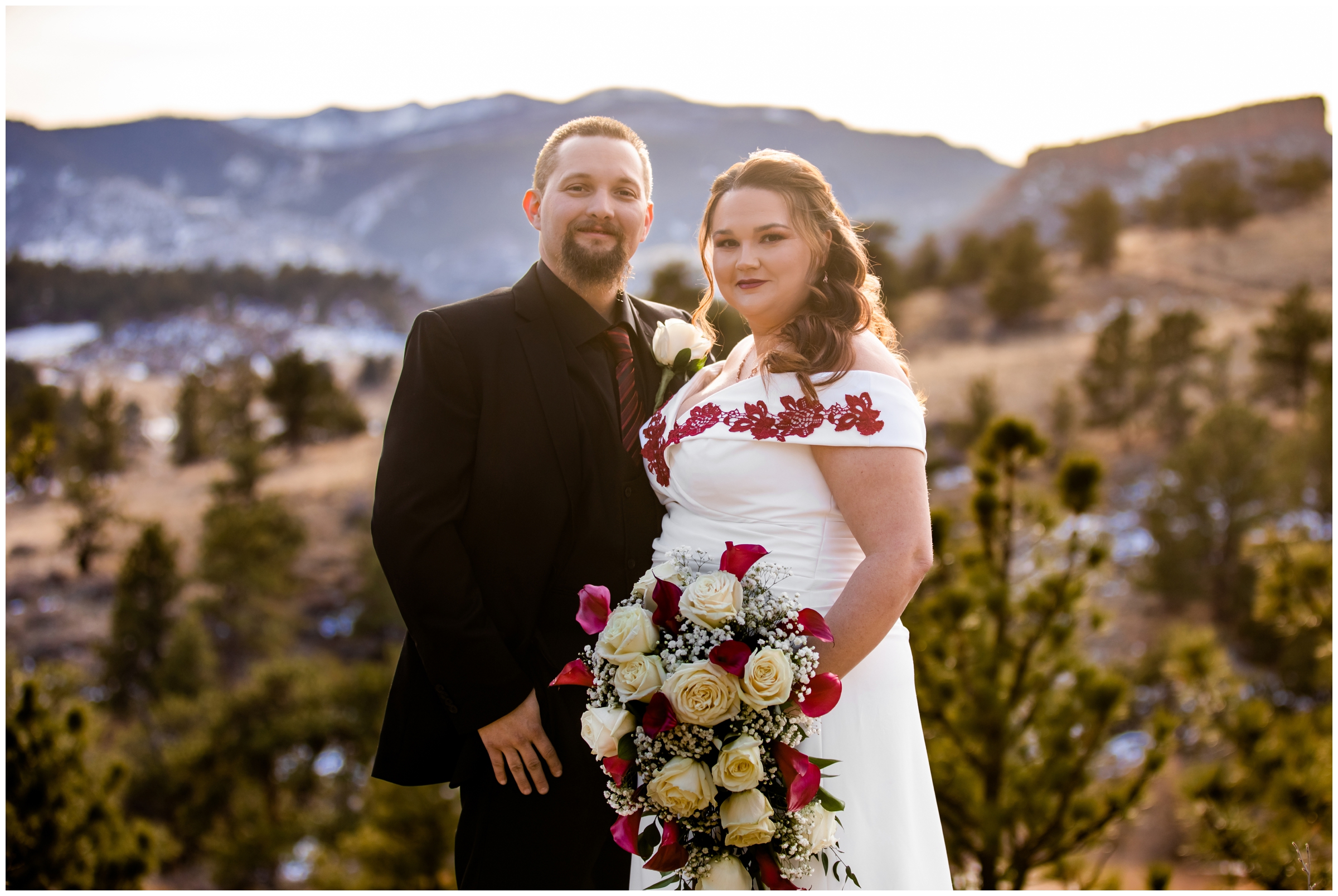couple posing in front of mountains at sunset during winter wedding pictures at Lionscrest Manor in Colorado 