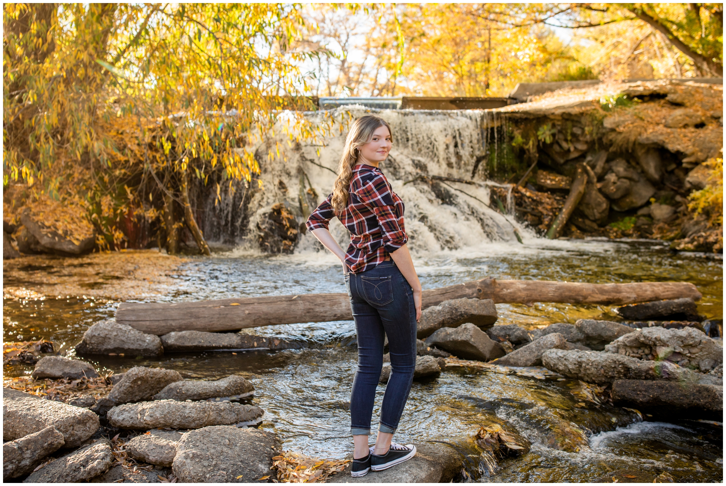 teen girl posing by waterfall at Golden Ponds Nature Area in Colorado