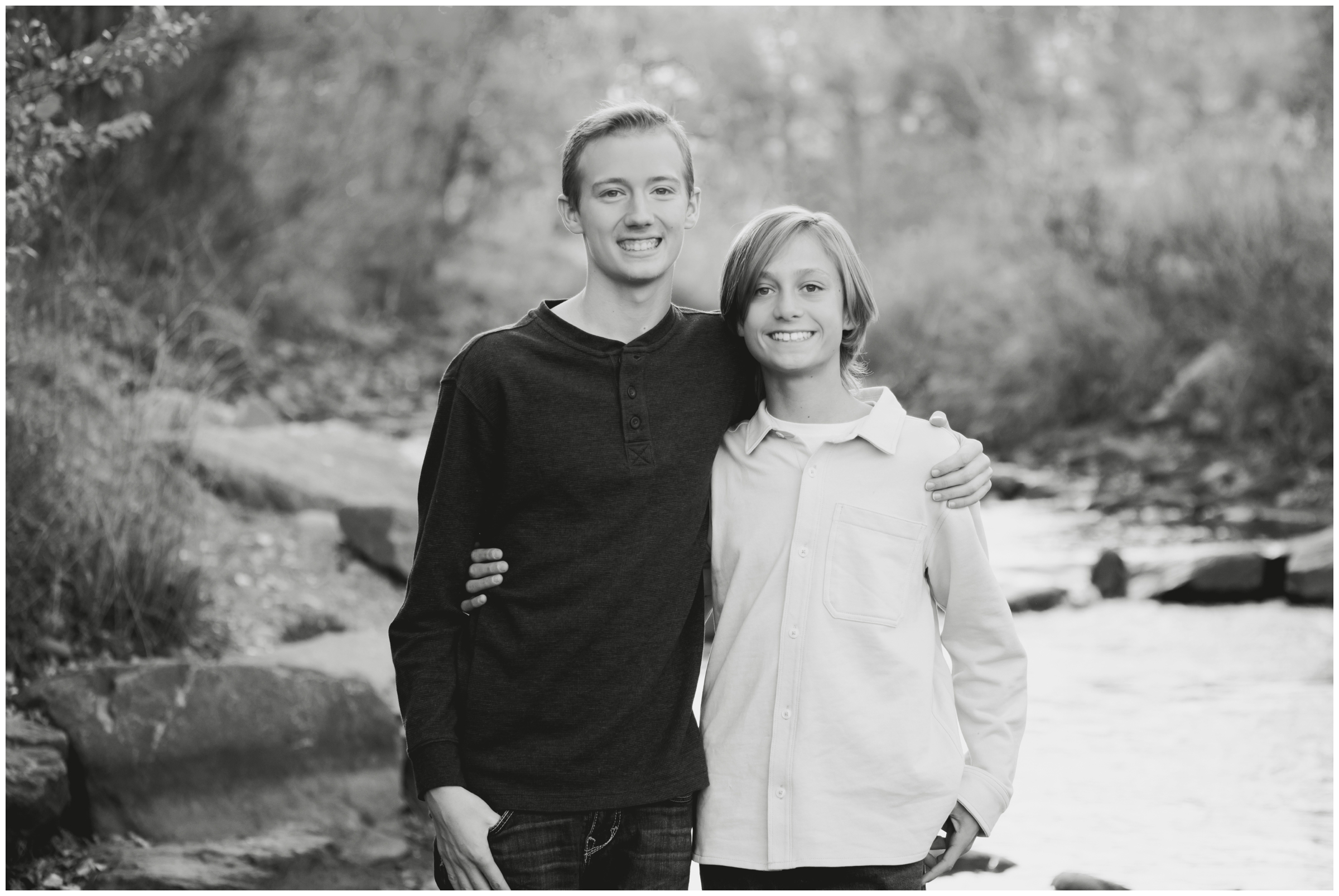 brothers posing next to river at Bohn Park in Lyons CO