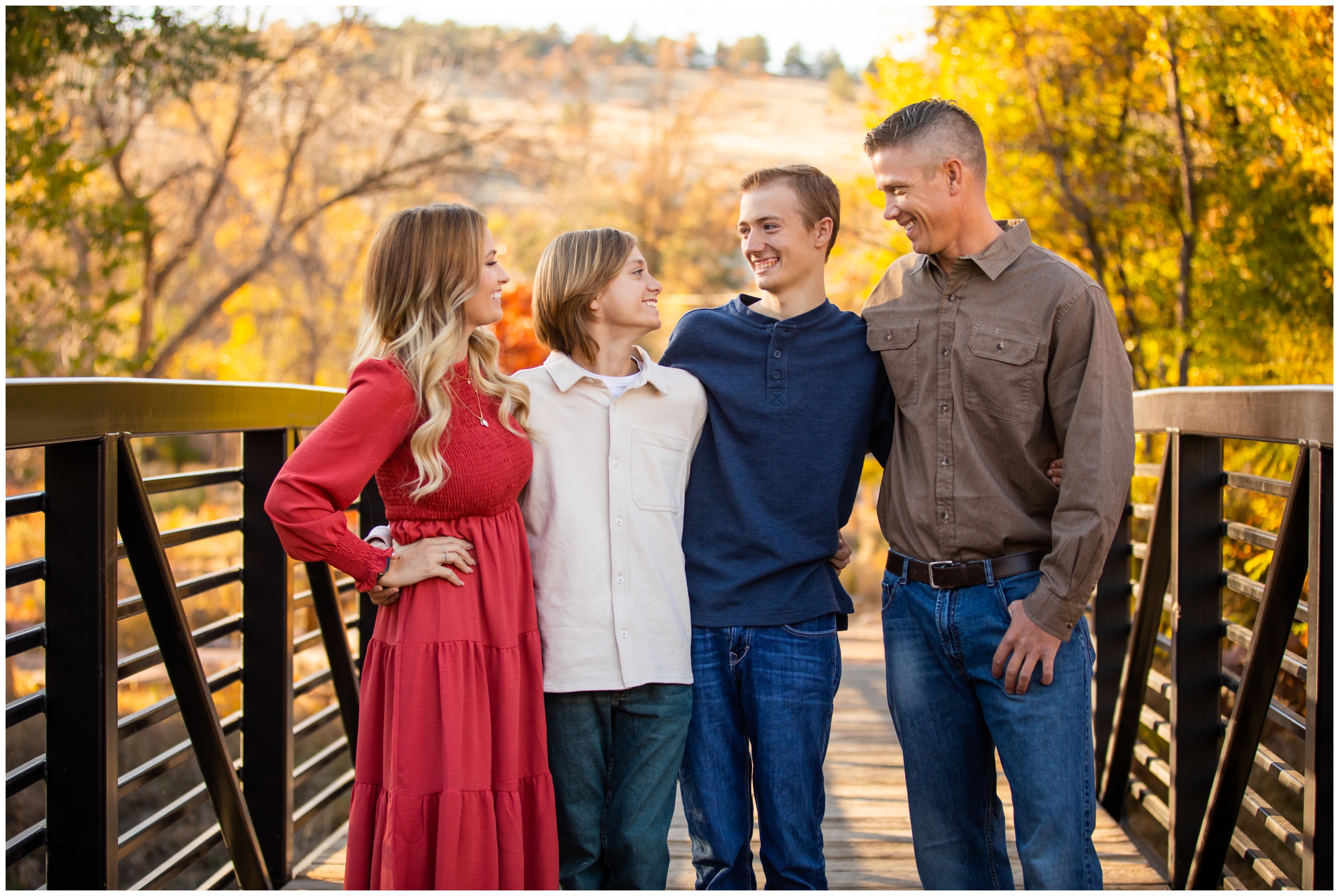 family laughing on a bridge during candid family photos in Lyons Colorado 